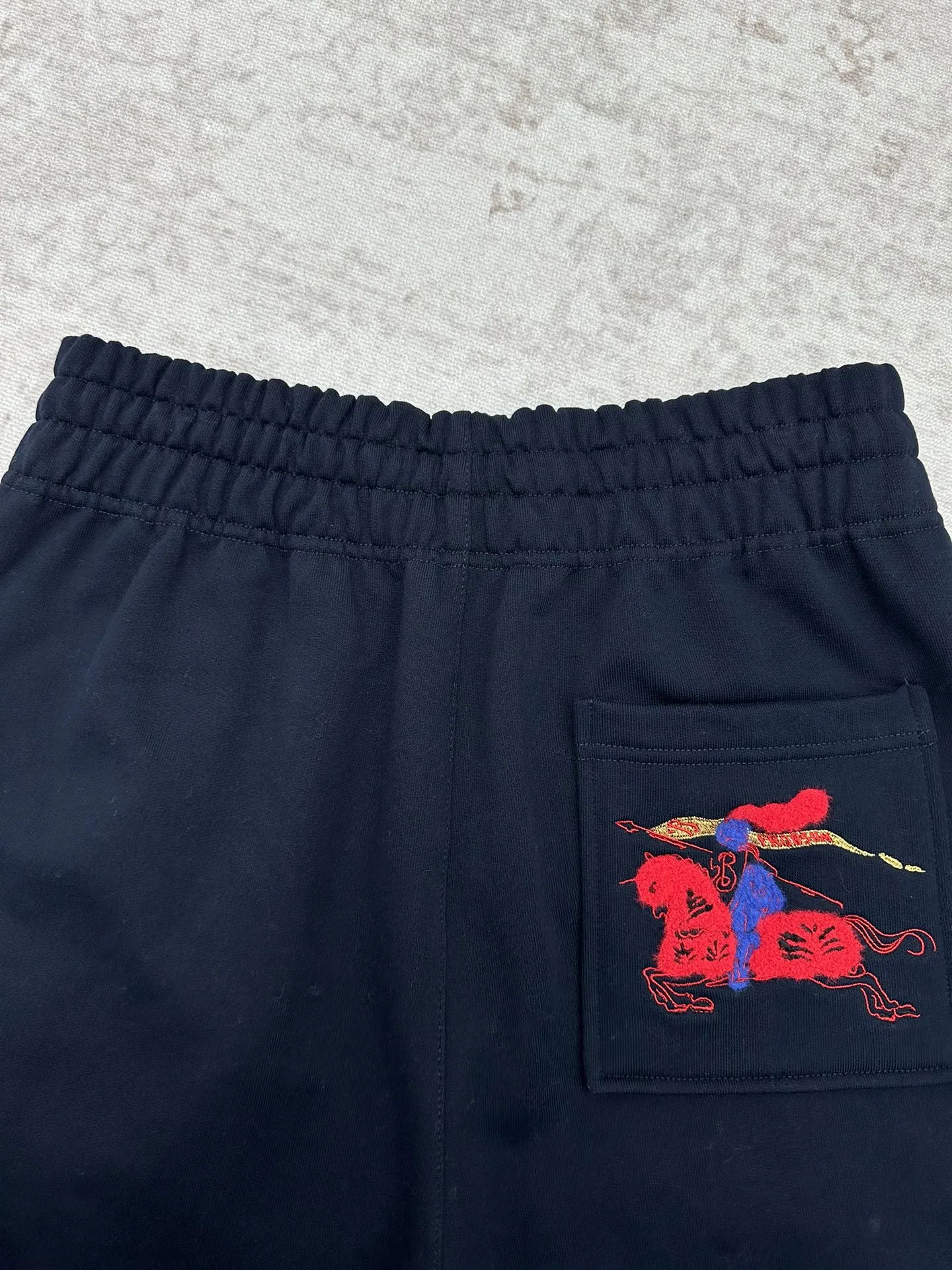 P195 巴宝莉 25ss新款棉质慢跑裤选用轻盈翻面绒棉质面料打造，呈现休闲版型。点缀新季马术骑士徽标（EKD）素描刺绣，融入金属感纱线。此件精品出自品牌新禧贺岁胶囊系列，礼赞马年新春。 码数：S.M.L.XL.