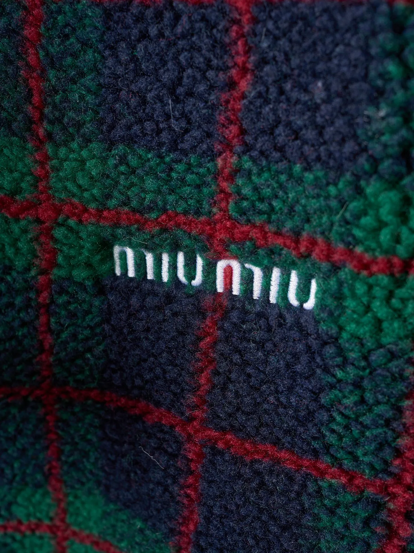 💰260【实物挂拍】MiuMiu/缪缪 羊羔绒格子刺绣拉链外套 【颜色】绿色 灰色 【现货】S M L XL 经典夹克在这款中被重新诠释，加入羊毛以增加厚度和柔软度。经典格纹图案汲取男装风格灵感，重新诠释运动女性气质的风格密码。 Oversize版型. 无衬里长袖立领.正面拉链开合 侧袋.双头钩针底边.刺绣徽标 采用80%羊毛，20%棉。该款面料原版定织定染，100%还原。内衬口袋布采用100%尼龙料， 后领位置搭配100%羊毛泰迪绒。 拉链采用尼龙与胶牙材料结合，拉牙采用欧款胶牙。下摆搭配原版刻字弹力扣。 刺绣采用3D立体刺绣工艺，刺绣logo饱满立体。呈现出高端视觉效果。