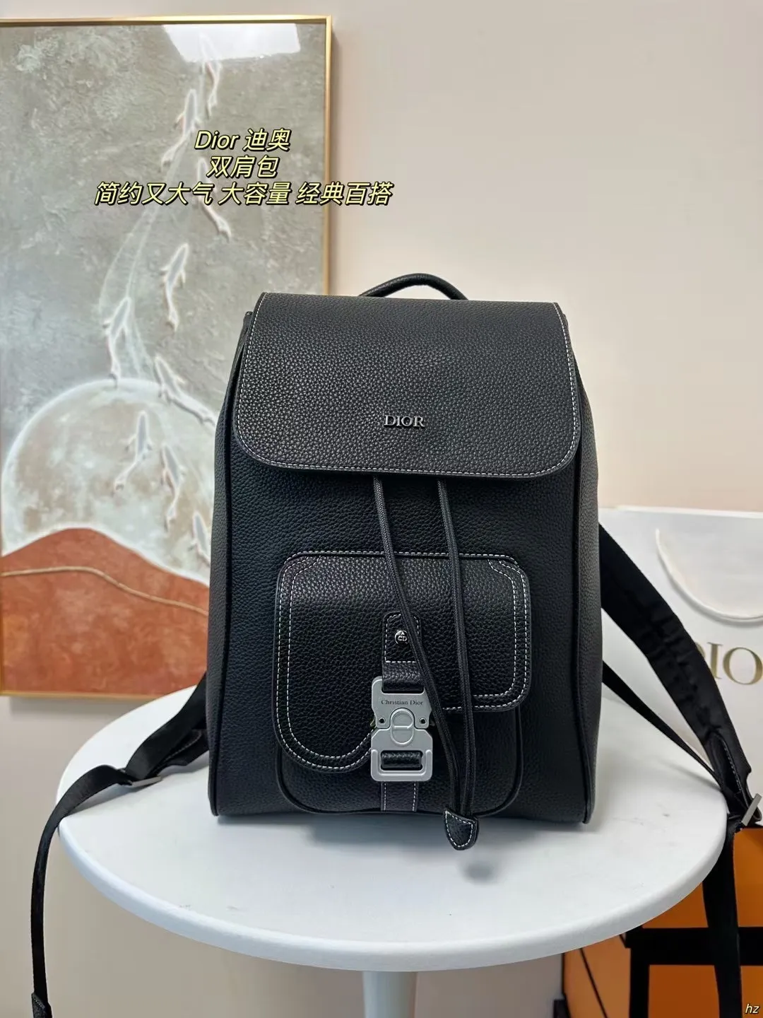 P185 Dior 迪奥 双肩包 这款马鞍双肩背包是二零二四秋季男装系列新品,采用时尚的原创设计,突显马鞍风格。黑色粒面牛皮革搭配对比鲜明的缉面线,正面饰以Dior标志。空间宽敞,设有一个隔层,可收纳各种日常用品,正面马鞍翻盖,可收纳钱包、钥匙、耳机或手机,便于轻松取用。实用百搭,是各式造型的点睛之笔。 尺寸:28*42CM