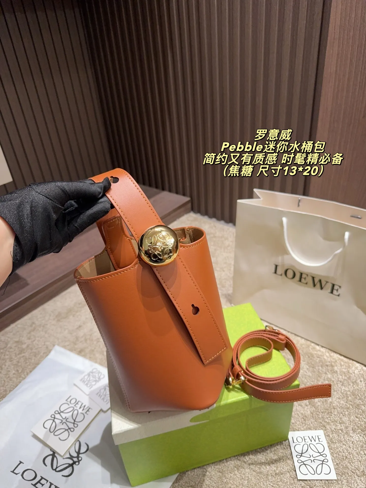 P150配盒⚠️尺寸13*20 LOEWE 罗意威Pebble迷你水桶包 采用柔软粒面小牛皮,手感细腻又耐用。黑色包身搭配金色按扣,简约又有质感。轻巧便携,通勤休闲都很适合。多种背法,手提、单肩、斜挎随心切换,满足不同场合需求品。内部空间合理,日常物品轻松收纳,实用又时髦!
