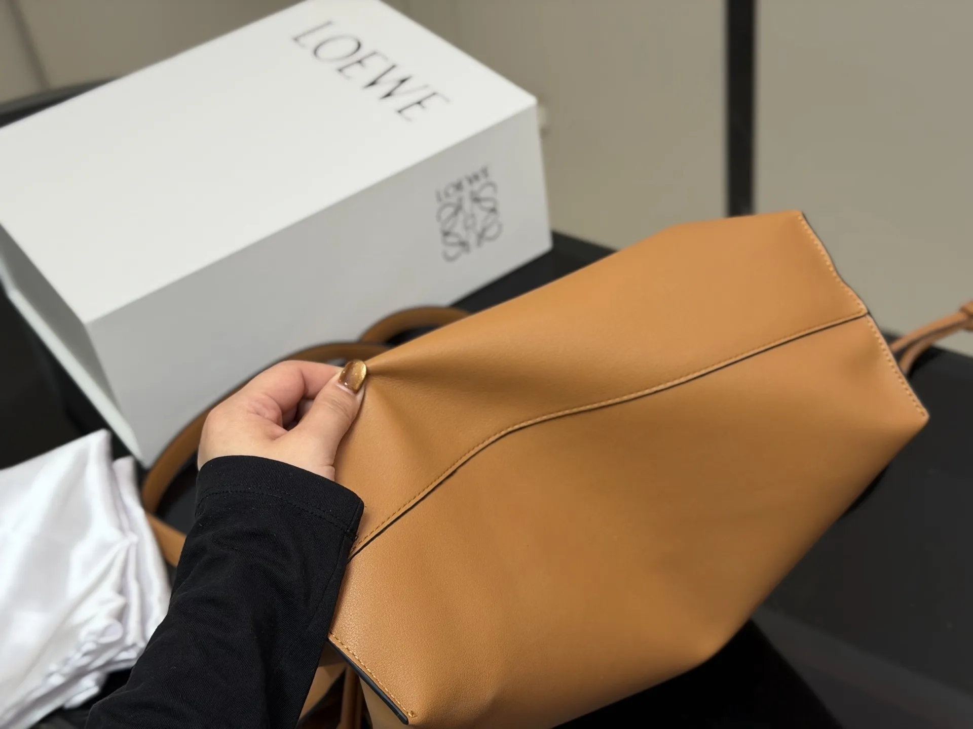 ¥300 配折叠盒 LOEWE 罗意威Anagram福袋托特包 采用柔软纳帕牛皮,手感细腻,廓形随性慵懒。灵感源自日本福袋,抽绳设计方便开合,容量超大,通勤日常都很实用。肩带可调节,支持单肩或斜挎,搭配Anagram印花,低调又有辨识度,时髦精们必入! 尺寸:37.29cm