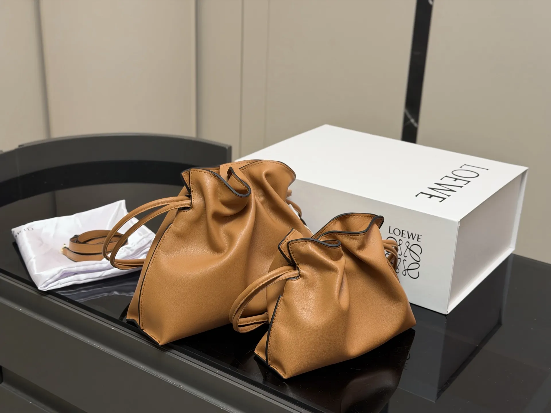 ¥235 ¥215 配折叠盒 Loewe 罗意威 Flamenco福袋包 手感柔软细腻,搭配Anagram金属标志,低调又奢华。容量大,通勤休闲都很适合。肩带可拆卸调节,手提、单肩、斜挎随心切换,灵活百搭國。磁扣开合方便,内部空问宽敞,收纳无压力。Flamenco 系列灵感源自西班牙弗拉门戈舞,优雅又有艺术气息。 尺寸:29.25cm 22.18cm