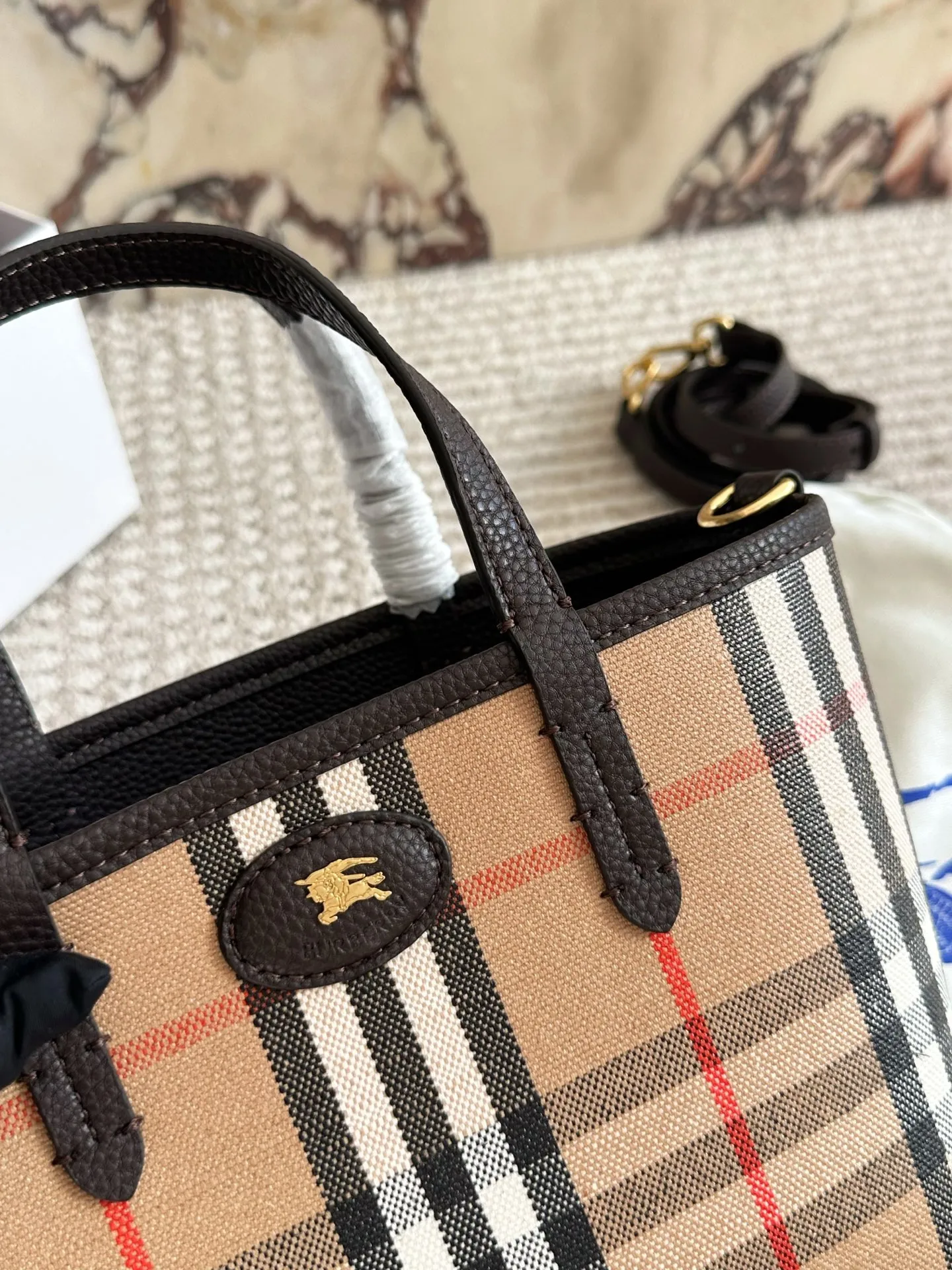 p190 双面tote Burberry家最新格纹迷你托特包，选用棉质帆布面料打造，格子面料搭配光滑皮革顶部提柄，有可调式斜背带。 顶部皮革提柄 可调式网纹肩背带开放式包口设计，搭配磁扣开合内侧口袋采用磁扣开合 尺寸 22 18cm 配盒