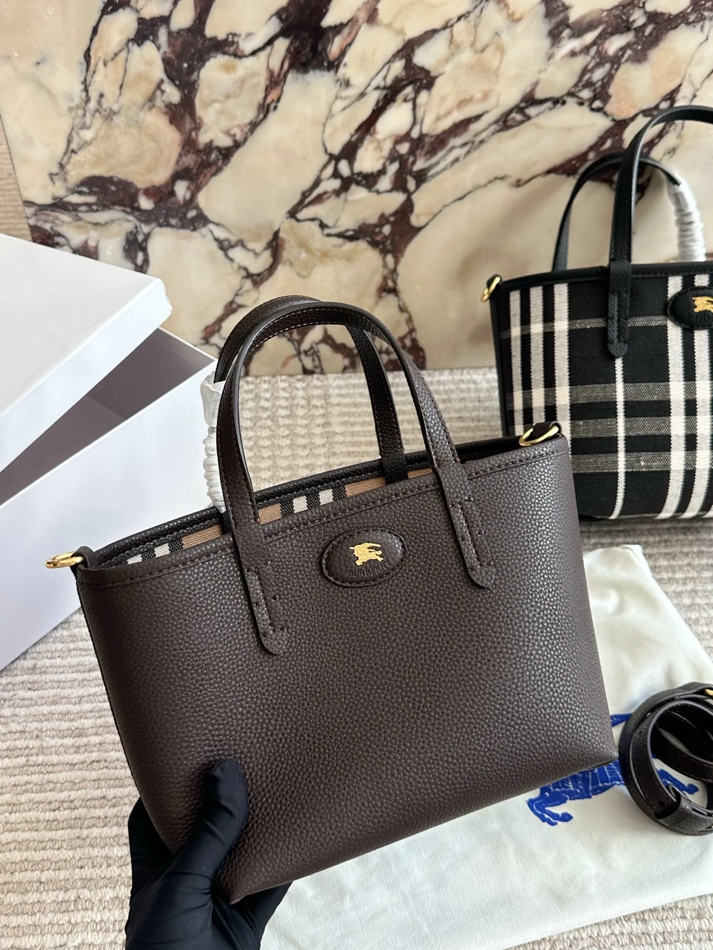 p190 双面tote Burberry家最新格纹迷你托特包，选用棉质帆布面料打造，格子面料搭配光滑皮革顶部提柄，有可调式斜背带。 顶部皮革提柄 可调式网纹肩背带开放式包口设计，搭配磁扣开合内侧口袋采用磁扣开合 尺寸 22 18cm 配盒
