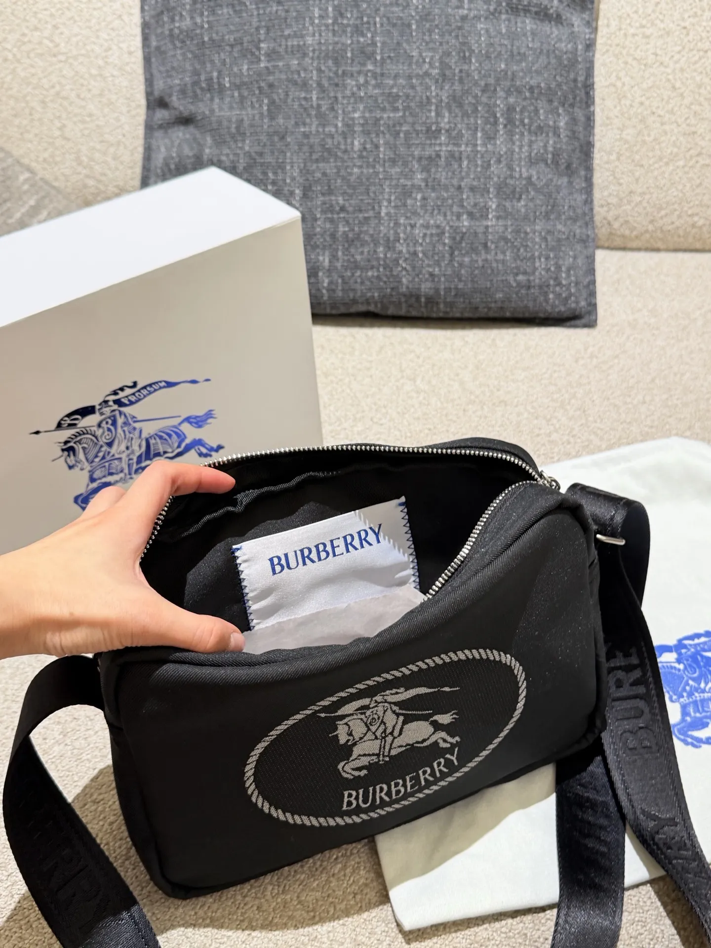 p160 巴宝莉男包秋冬季轻便穿搭 巴宝莉 斜背包，装饰与内衬配色呼应的精纺崁纱骑士印章，以反光纱线打造，源自 1980 年代品牌包款的典藏图案。肩背带点缀同色系 Bur字母徽标，可调节缔造肩背或斜挎造型。 尺寸:26.5 x 9 x 18cm配盒子