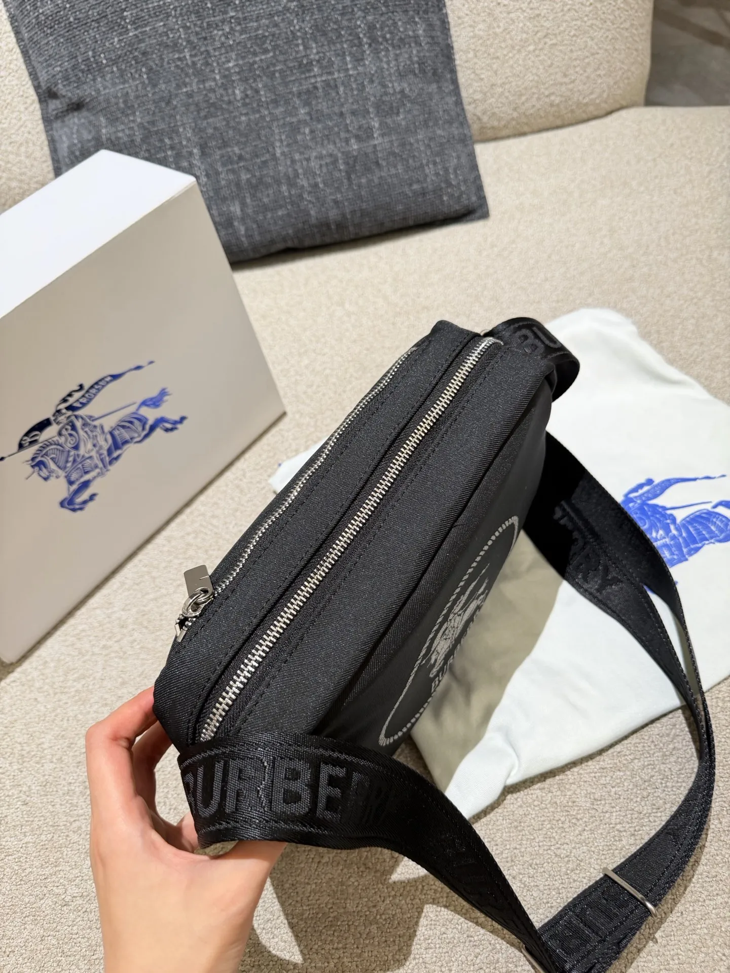 p160 巴宝莉男包秋冬季轻便穿搭 巴宝莉 斜背包，装饰与内衬配色呼应的精纺崁纱骑士印章，以反光纱线打造，源自 1980 年代品牌包款的典藏图案。肩背带点缀同色系 Bur字母徽标，可调节缔造肩背或斜挎造型。 尺寸:26.5 x 9 x 18cm配盒子