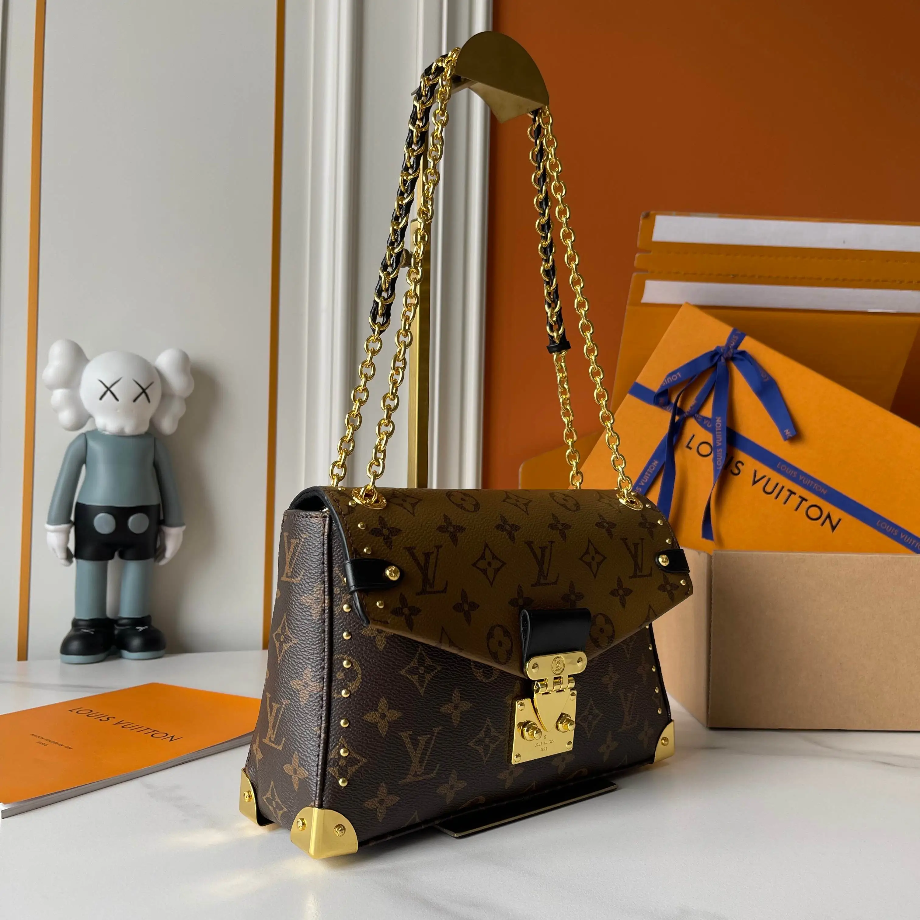 升级版批 150 M14526 M25081 M81266 Trunkie 手袋结合 Monogram 帆布和金属铆钉,搭配金属质感包角和标志性 S-lock 锁扣,以复古行李箱格调彰显品牌传承。内部空间和拉链口袋方便容纳日常所需,滑链肩带拓展背携选择。 16 x 8 x 27 厘米 (高 x 宽 x 长度) 涂层帆布 牛皮革饰边 织物内衬 金属件 翻盖开合,配有 S-lock 锁扣 拉链内袋 可收纳 6.7 寸智能手机、Sarah 长款钱夹、笔记本、太阳眼镜和钥匙 链条:可滑动调整,可拆卸 链条半长:20.0 厘米 链条半长可调至:28.0 厘米