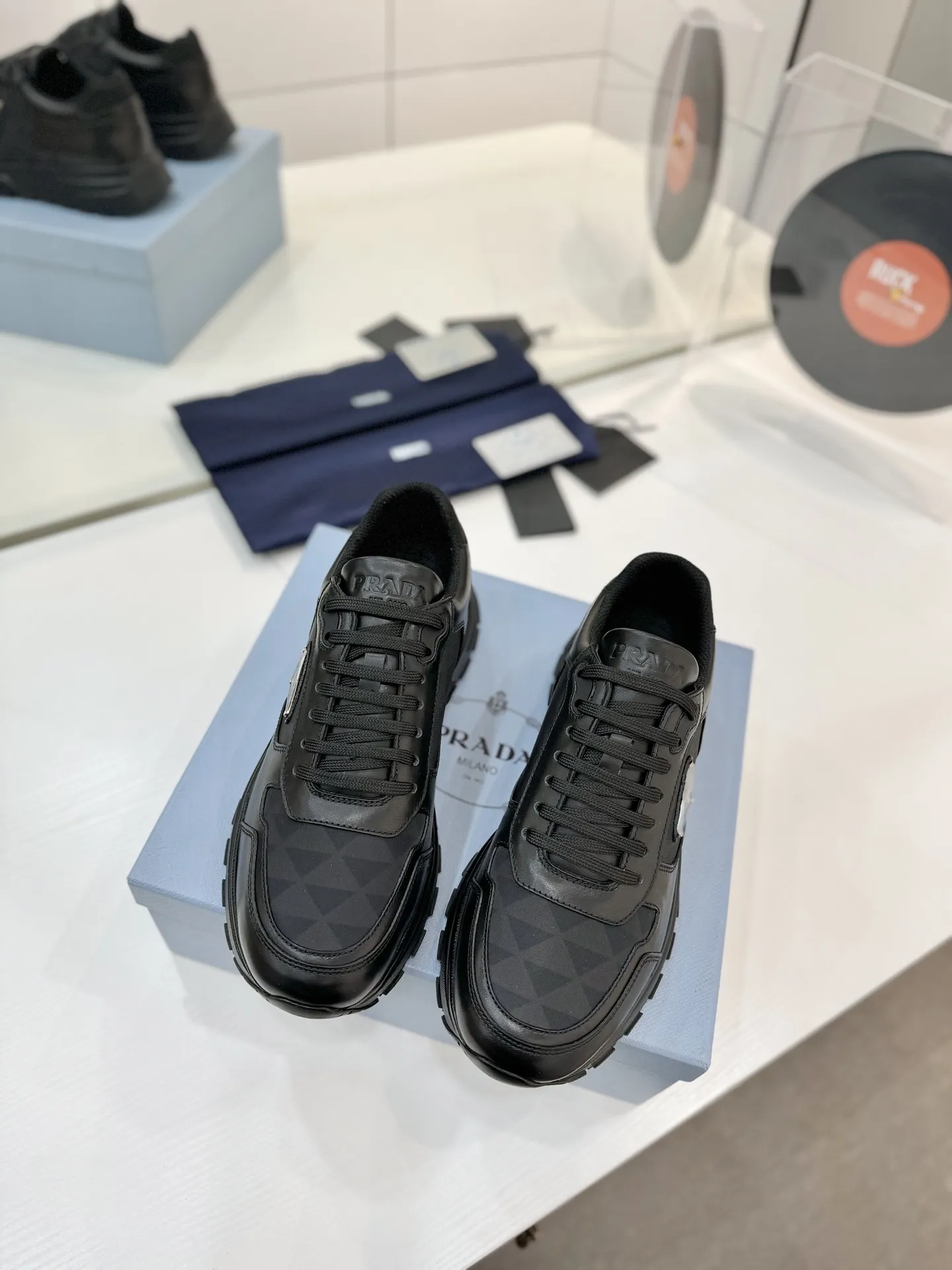 工厂价💰310男➕10🔥《普拉达prada》运动鞋融优雅的创意设计以及Prada系列典型的材质于一身。 ⚡️鞋身采用海洋塑料回收物所制的创新性Re-Nylon再生尼龙和亮面牛皮革打造。蕴含新颖运动格调的三角形徽标点缀侧面，彰显品牌特色。胎面花纹厚底赋予廓形混搭魅力。原版1比1开发， ✅鞋面：采用进口小牛皮拼接透气网面， 鞋舌Prada Milano丝网印刷徽标 ✅外侧饰经典金属三角珐琅徽标 ✅内里：网布，垫脚牛皮， ✅大底：采用防滑运动专属带logo橡胶大底 ✅码数：35-46（订制45.46）