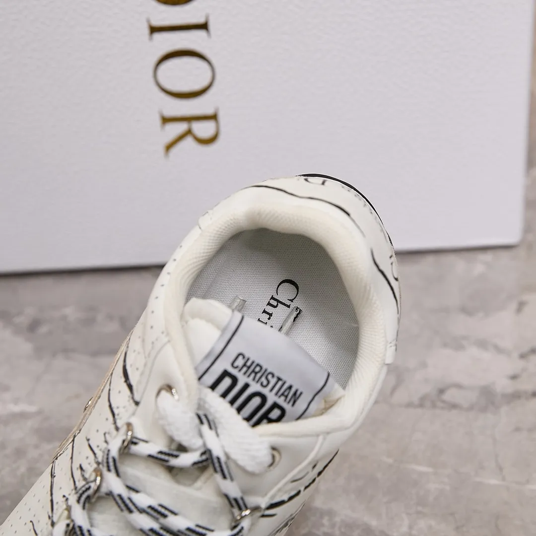 p300 迪奥 / Dior D-Sketch 运动鞋 男女35-45 白色尼龙和牛皮革 这款 D-Sketch 运动鞋于迪奥二零二五春夏成衣系列发布秀精彩亮相,彰显经典的复古美学。采用白色尼龙和牛皮革精心制作,饰以灵感源自鞋履制作阶段的印花标志,搭配米色绒面牛皮革镶片和双鞋带。侧面饰以手写风格的 Christian Dior Paris 标志,鞋跟和鞋舌点缀以 Christian Dior Paris 标志镶片和标牌。搭配双色纤薄橡胶鞋底更显精致,可为各式休闲造型增添高订气质。 帮面材质:牛皮革,牛剖层革,织物 装饰物及装饰线除外 侧面、鞋舌和鞋跟饰以 Christian Dior Paris 标志 双色纤薄橡胶鞋底饰以 Christian Dior 的幸运星符号