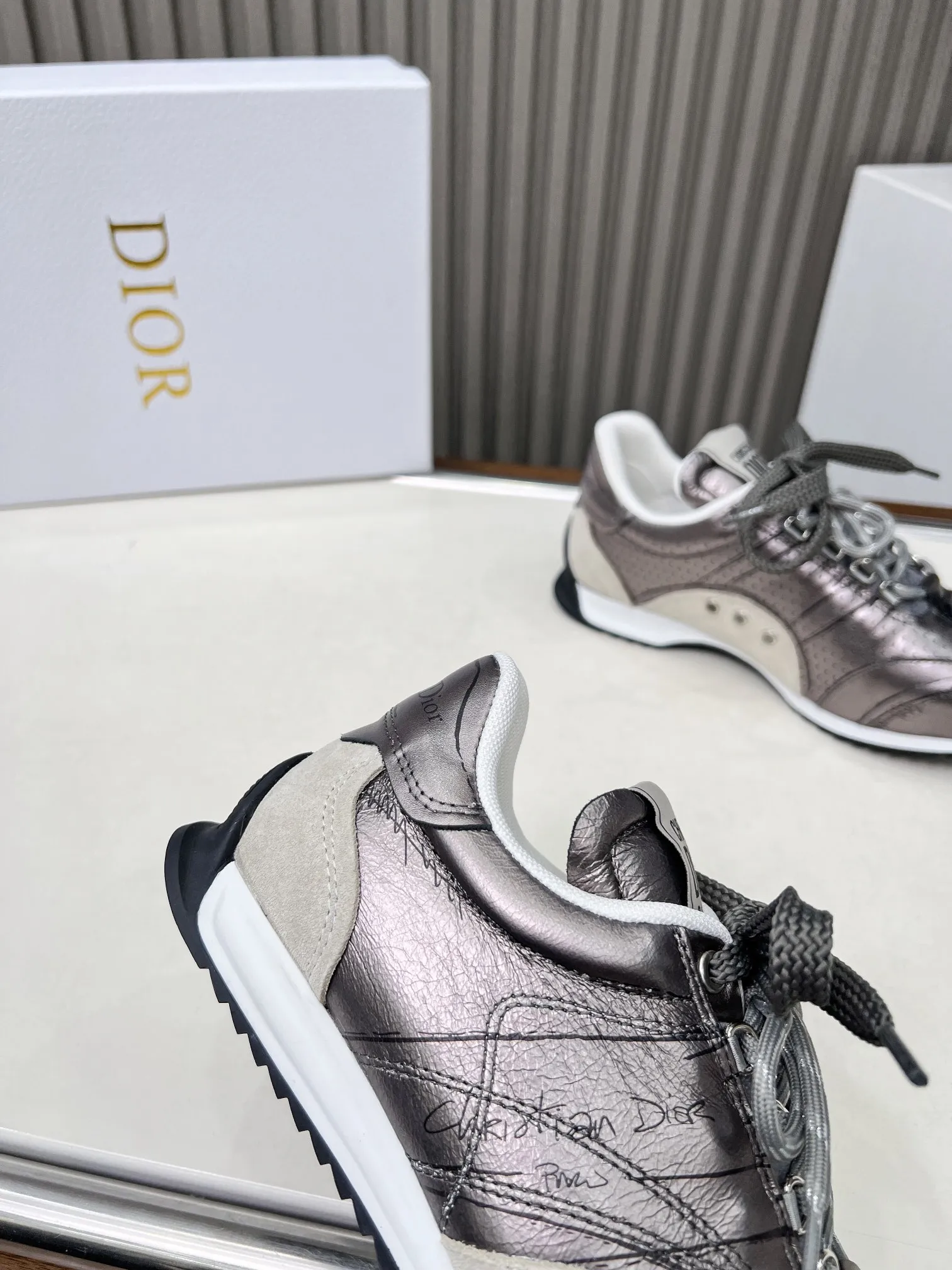 p270 这款 D-Sketch运动鞋是二零二五春夏成衣系列新品，彰显经典的复古美学。采用金色调褶皱羊皮革和金色调叠层牛皮革等材质精心制作，饰以灵感源自鞋履制作阶段的印花标志，搭配米色绒面牛皮革镶片和双鞋带。侧面饰以手写风格的Christian Dior Paris标志，鞋跟和鞋舌点缀以Christian Dior Paris 标志镶片和标牌。搭配双色纤薄橡胶鞋底更显精致，可为各式休闲造型增添高订气质。 码数：35~41（男款打板中） 颜色：黑 白 金 银