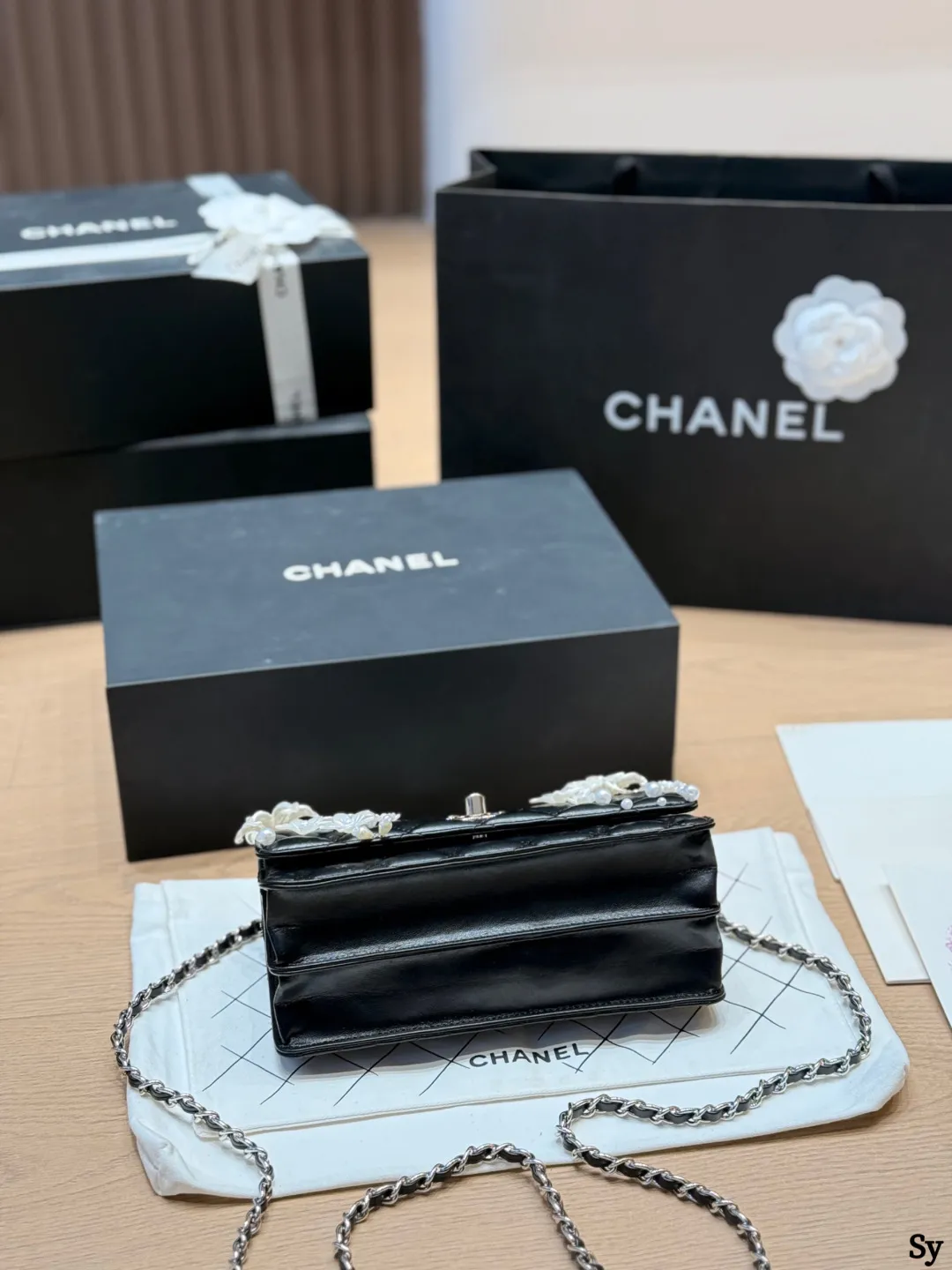 Chanel black quilted leather flap bag with 3D camellia flowers and pearl handle - xiashuluxe