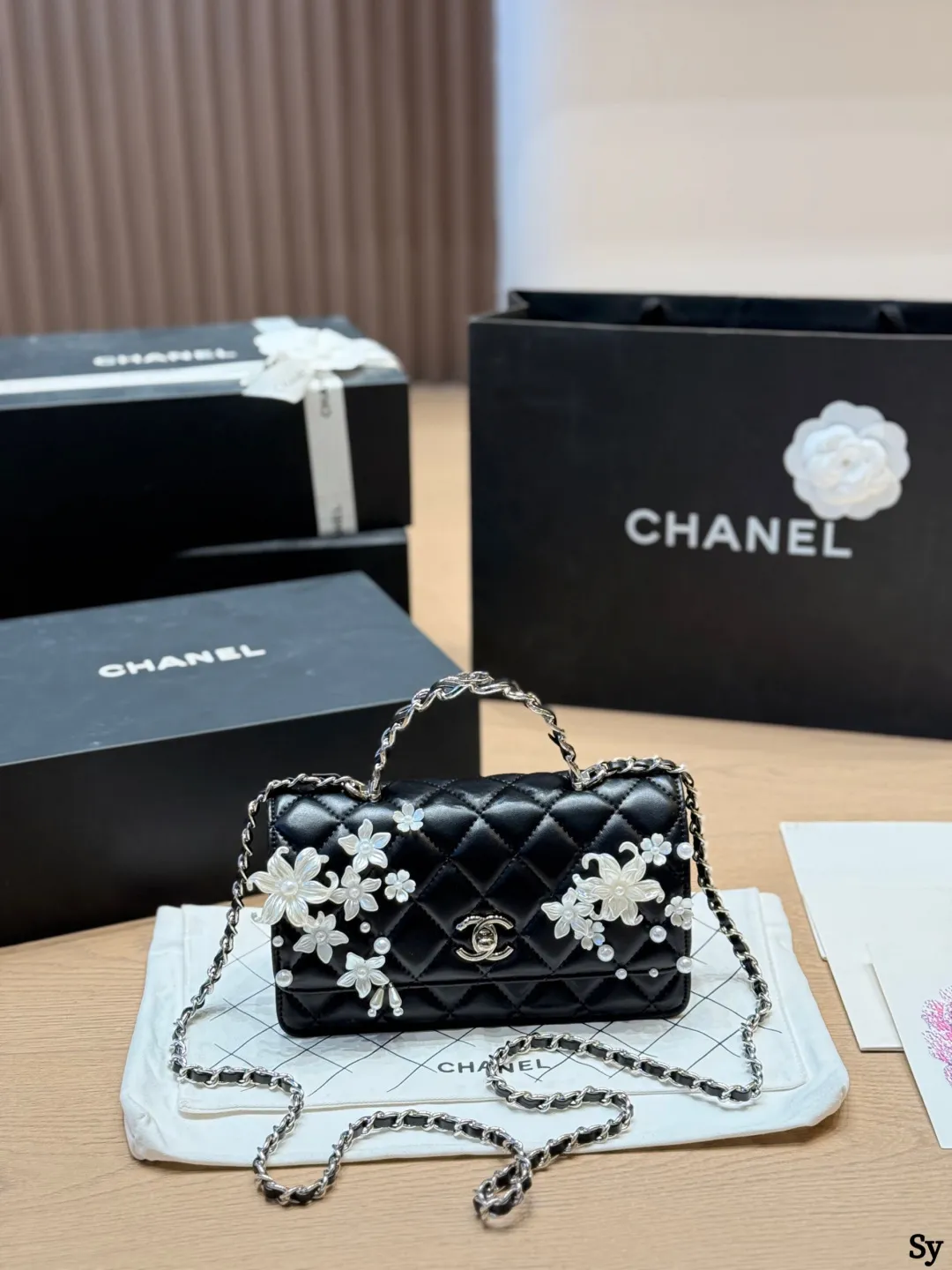 Chanel black quilted leather flap bag with 3D camellia flowers and pearl handle - xiashuluxe