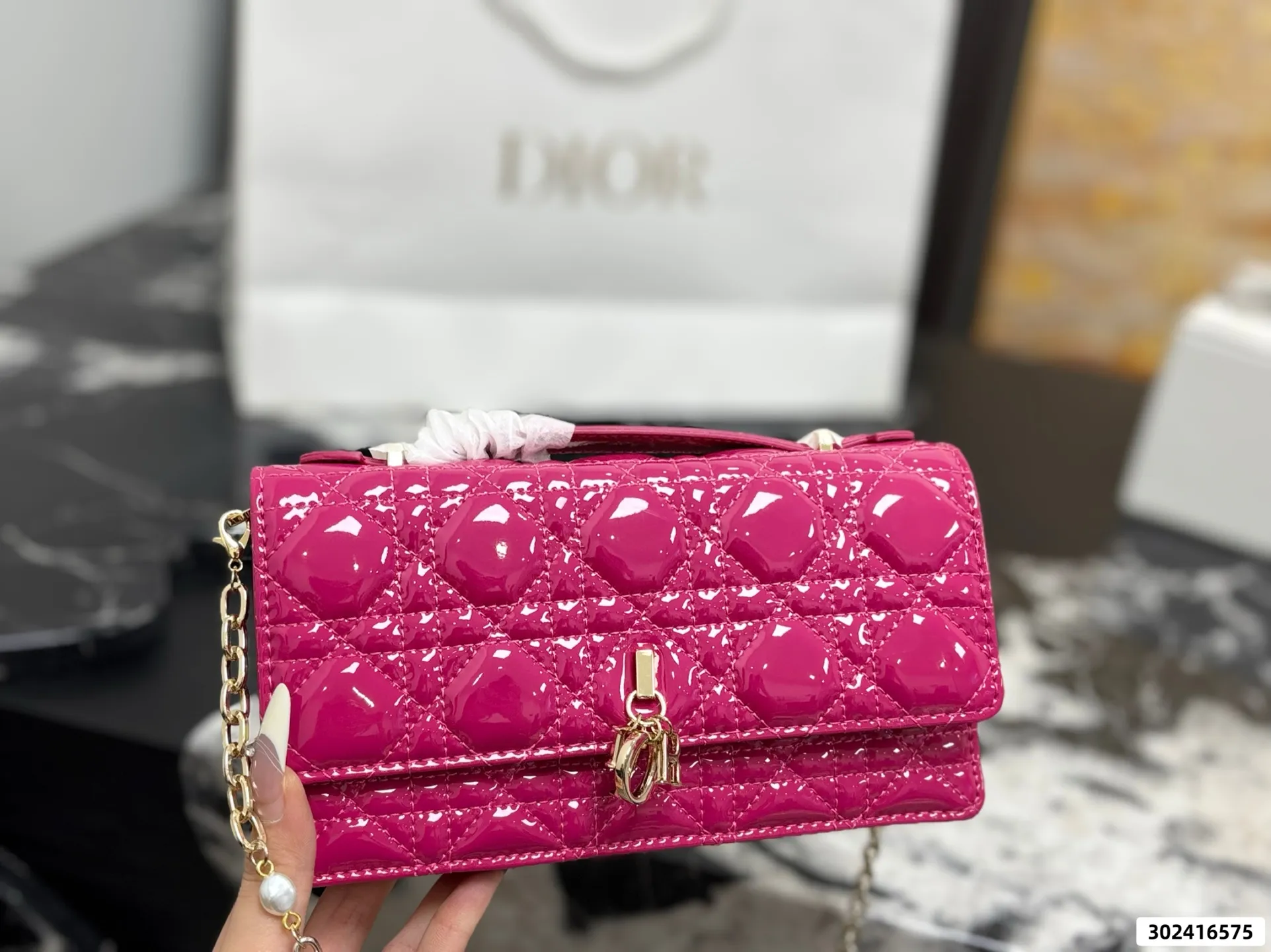 Collection of Lady Dior pouches in colorful patent leather with gold charms and luxury packaging - xiashuluxe