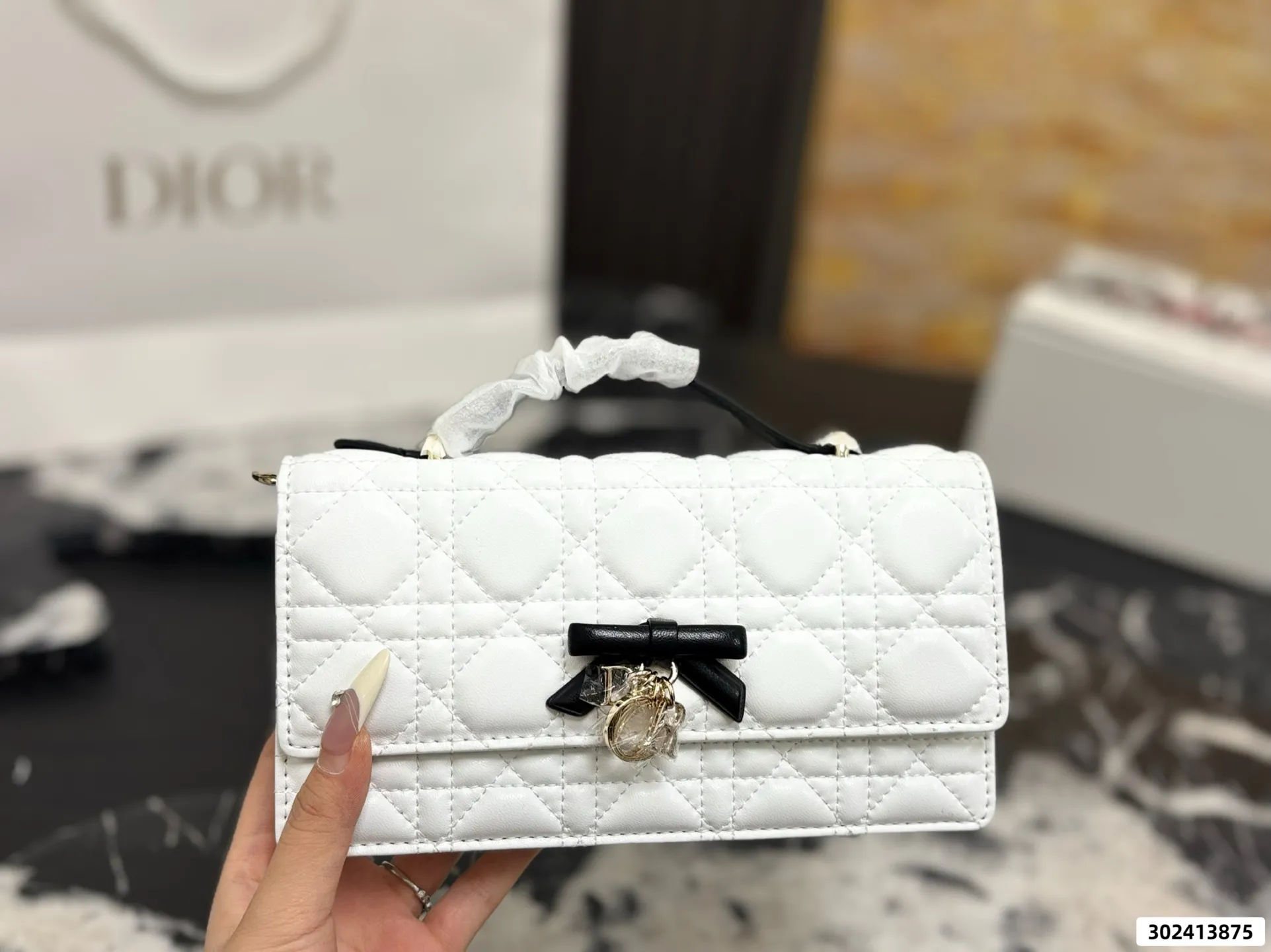 Collection of Lady Dior pouches in various colors including black, pink, and beige with luxury packaging - xiashuluxe