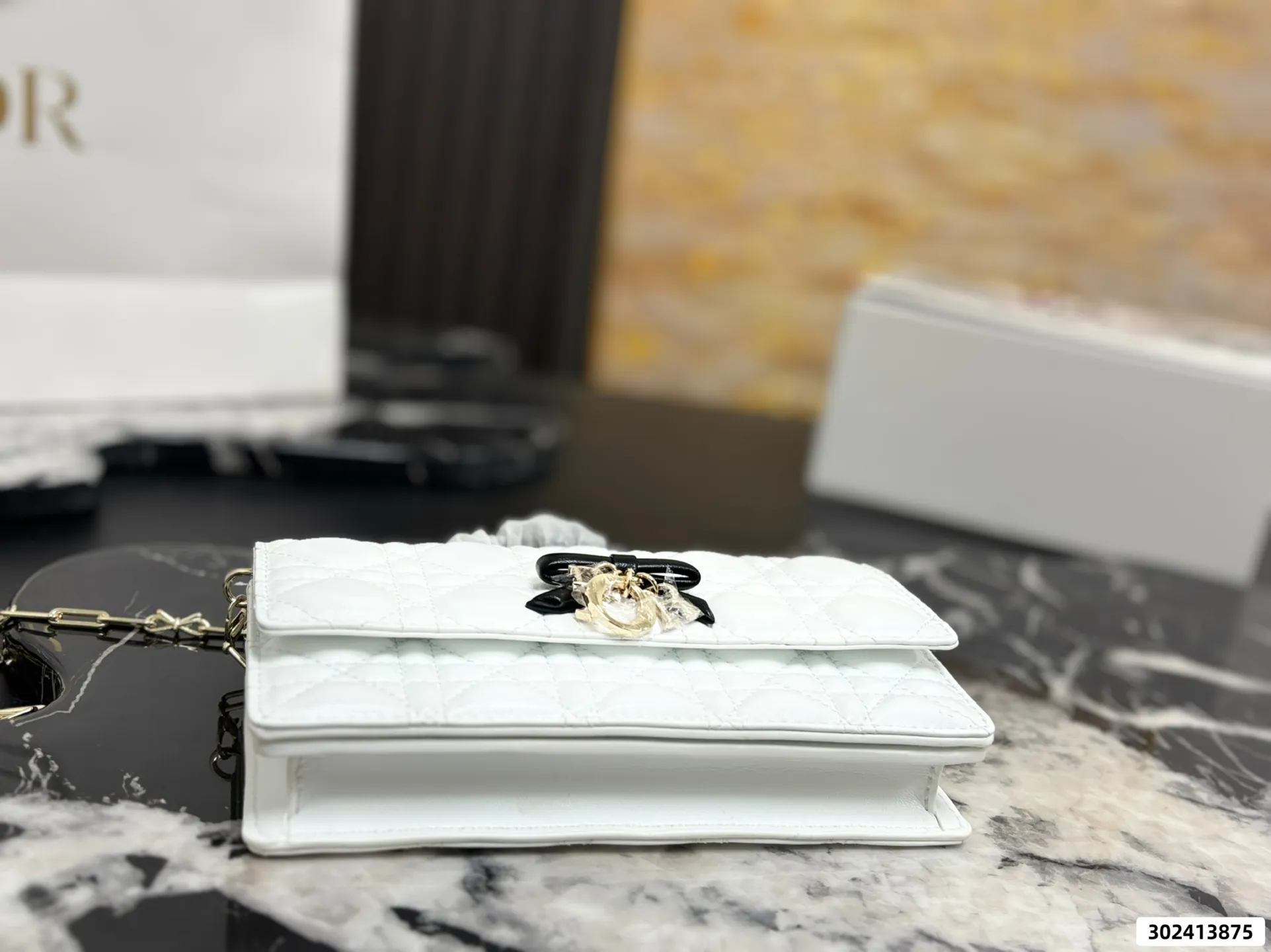 Collection of Lady Dior pouches in various colors including black, pink, and beige with luxury packaging - xiashuluxe