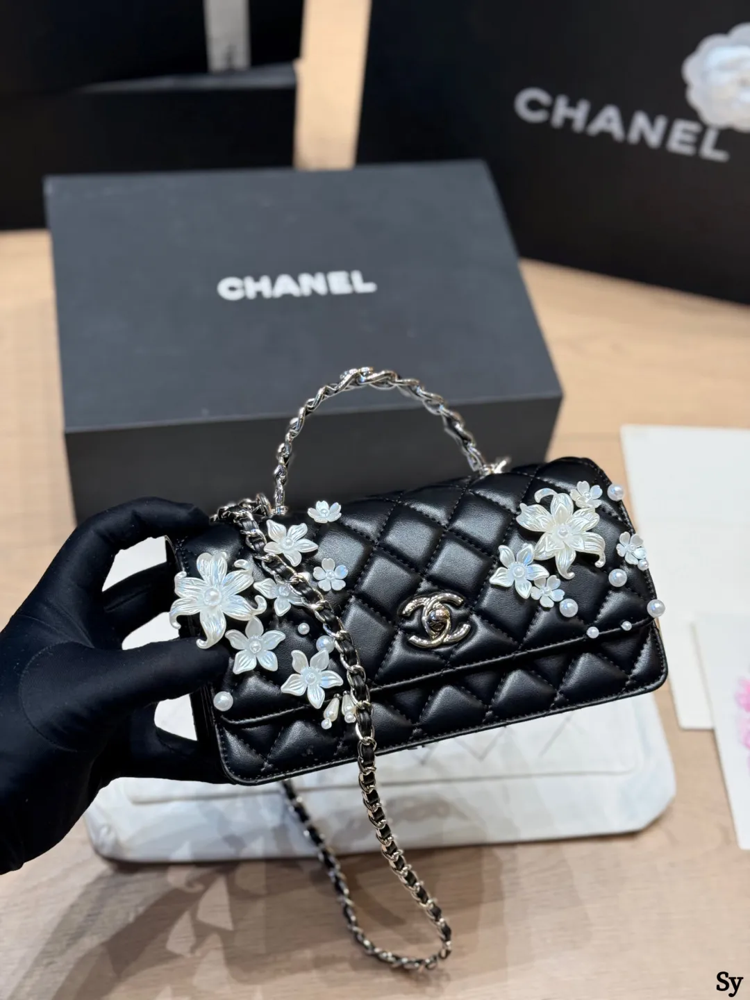 Chanel black quilted leather flap bag with 3D camellia flowers and pearl handle - xiashuluxe