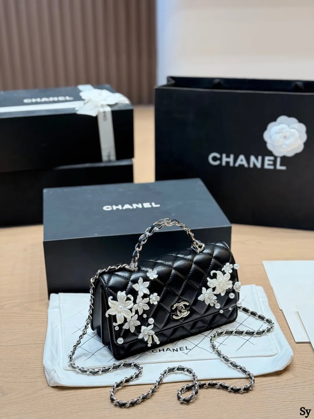Chanel black quilted leather flap bag with 3D camellia flowers and pearl handle - xiashuluxe