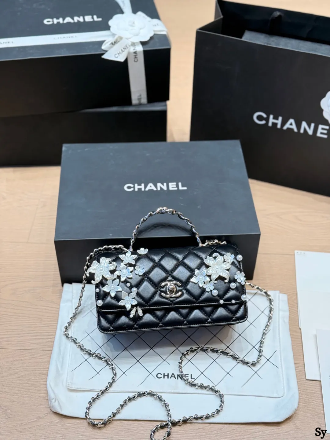 Chanel black quilted leather flap bag with 3D camellia flowers and pearl handle - xiashuluxe