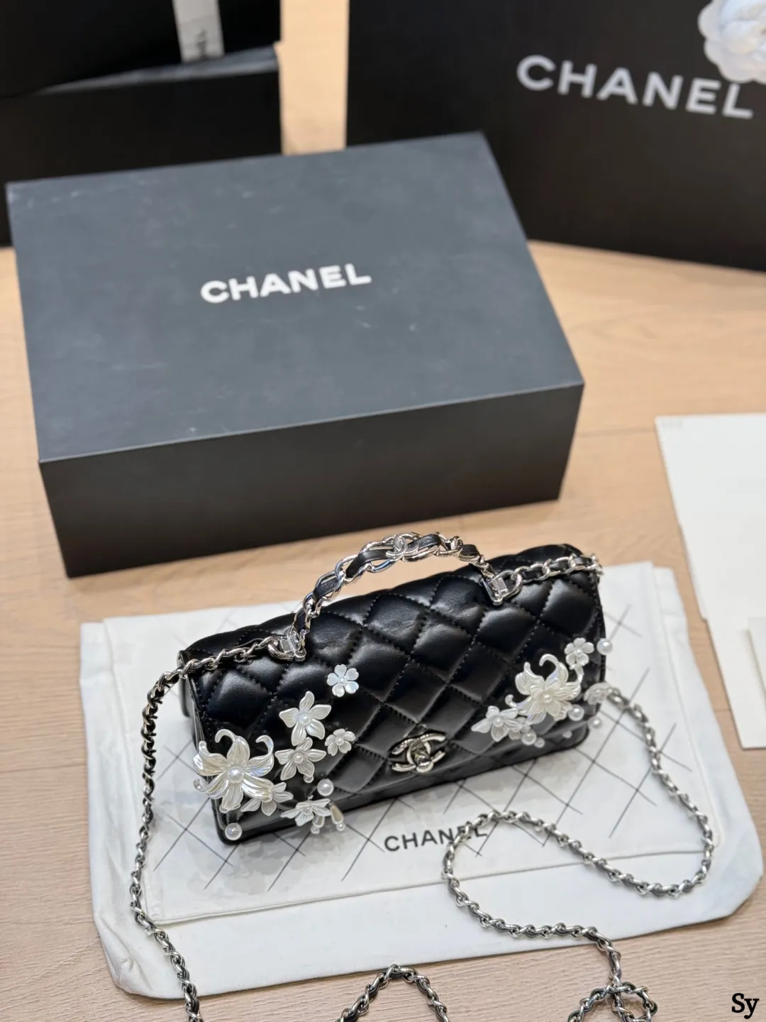 Chanel black quilted leather flap bag with 3D camellia flowers and pearl handle - xiashuluxe