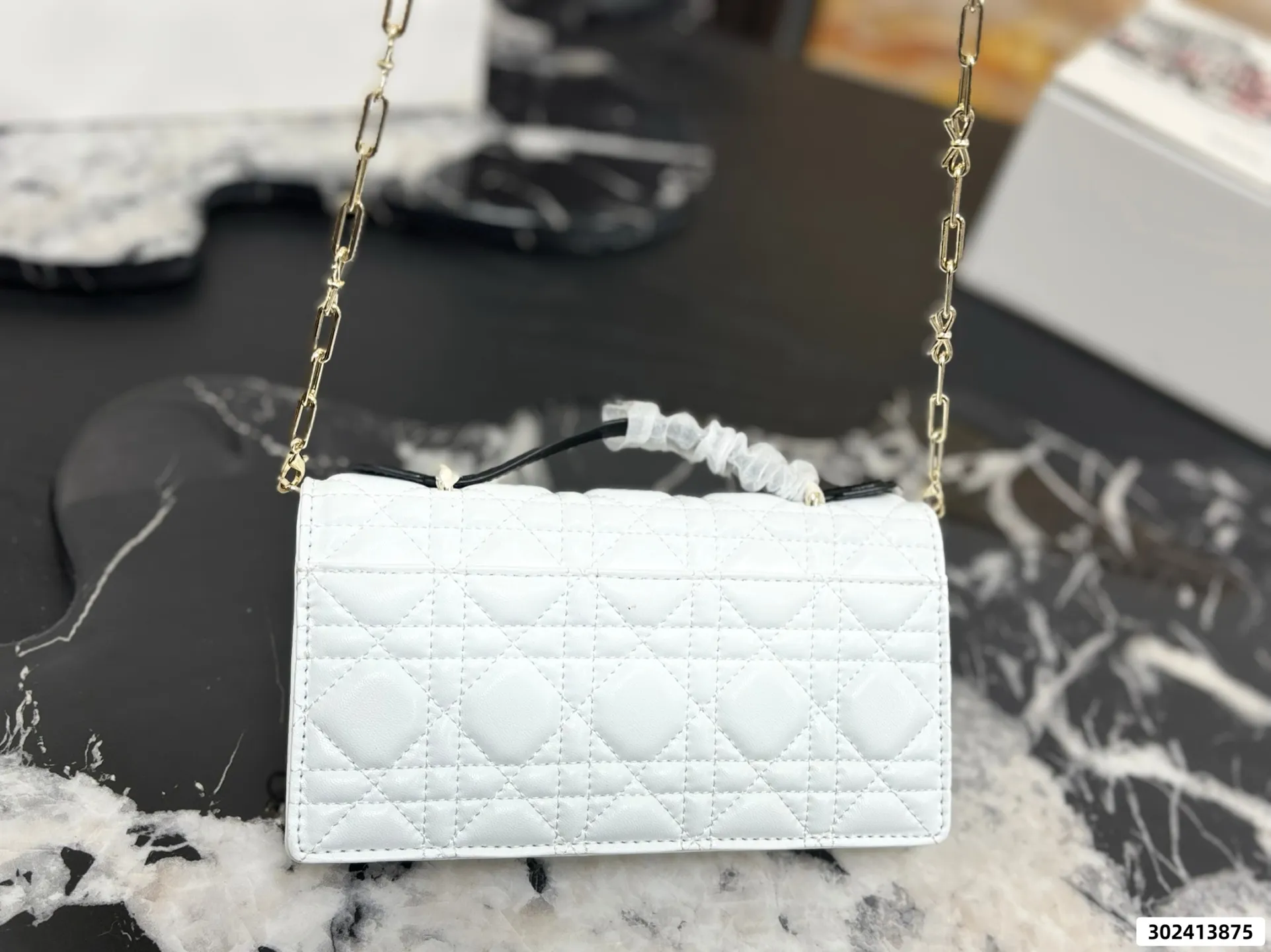 Collection of Lady Dior pouches in various colors including black, pink, and beige with luxury packaging - xiashuluxe