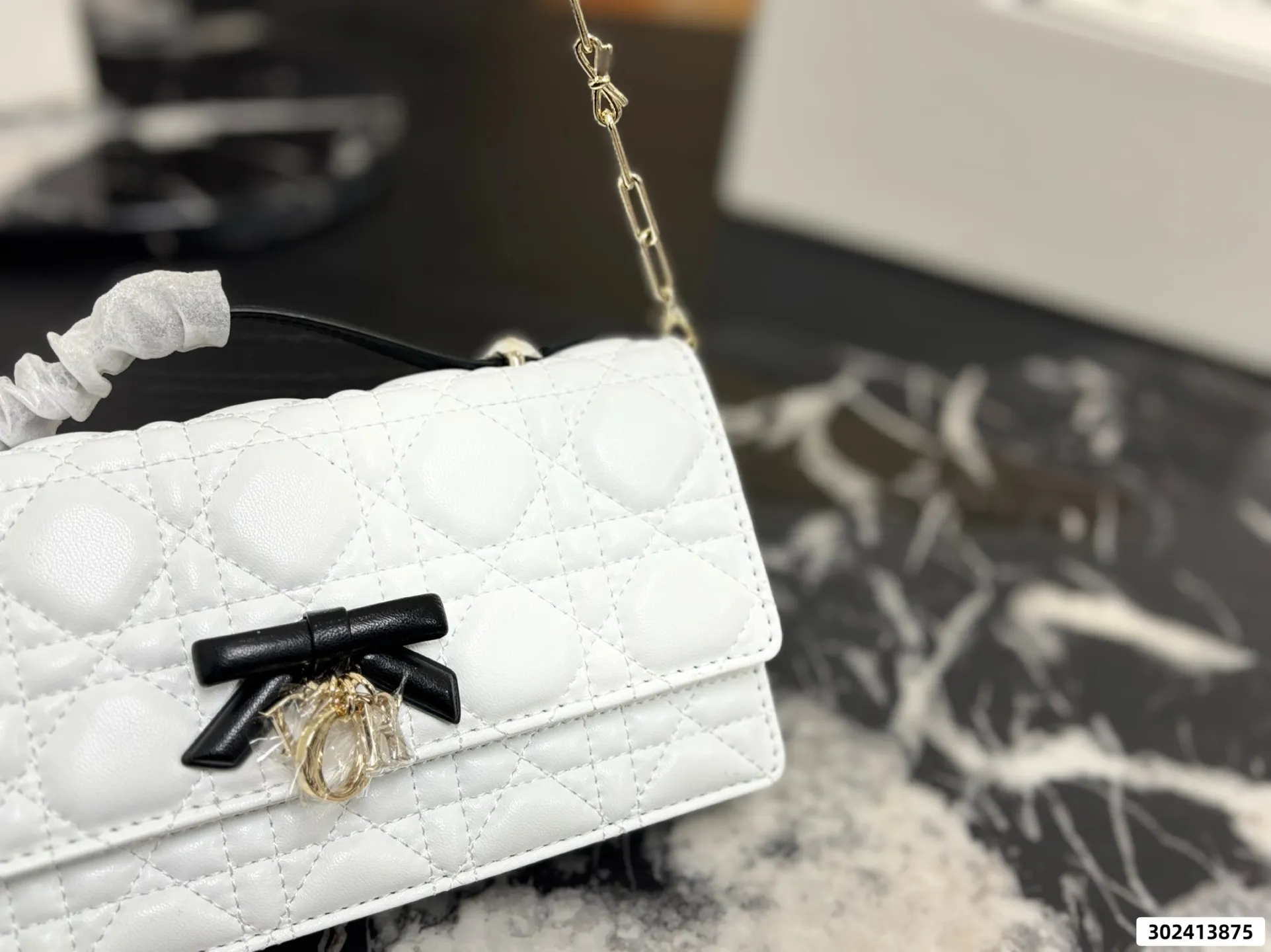 Collection of Lady Dior pouches in various colors including black, pink, and beige with luxury packaging - xiashuluxe