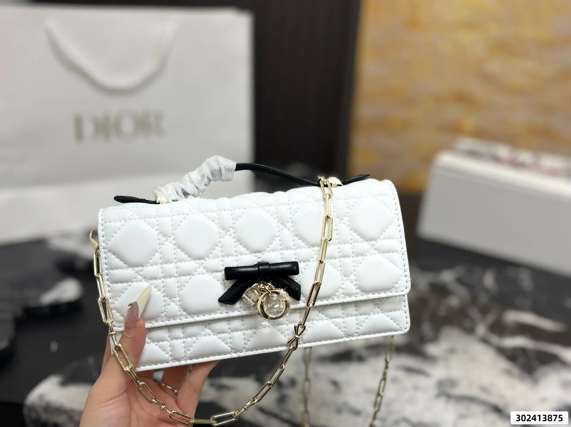 Collection of Lady Dior pouches in various colors including black, pink, and beige with luxury packaging - xiashuluxe