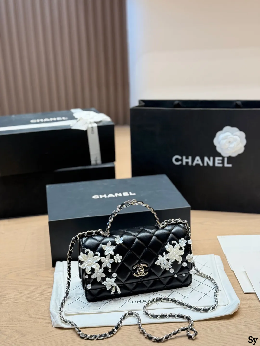 Chanel black quilted leather flap bag with 3D camellia flowers and pearl handle - xiashuluxe