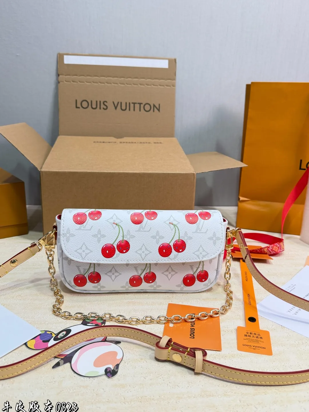 1:1Louis Vuitton Cherry Pochette Accessoires Monogram canvas bag with luxury packaging on table - xiashu