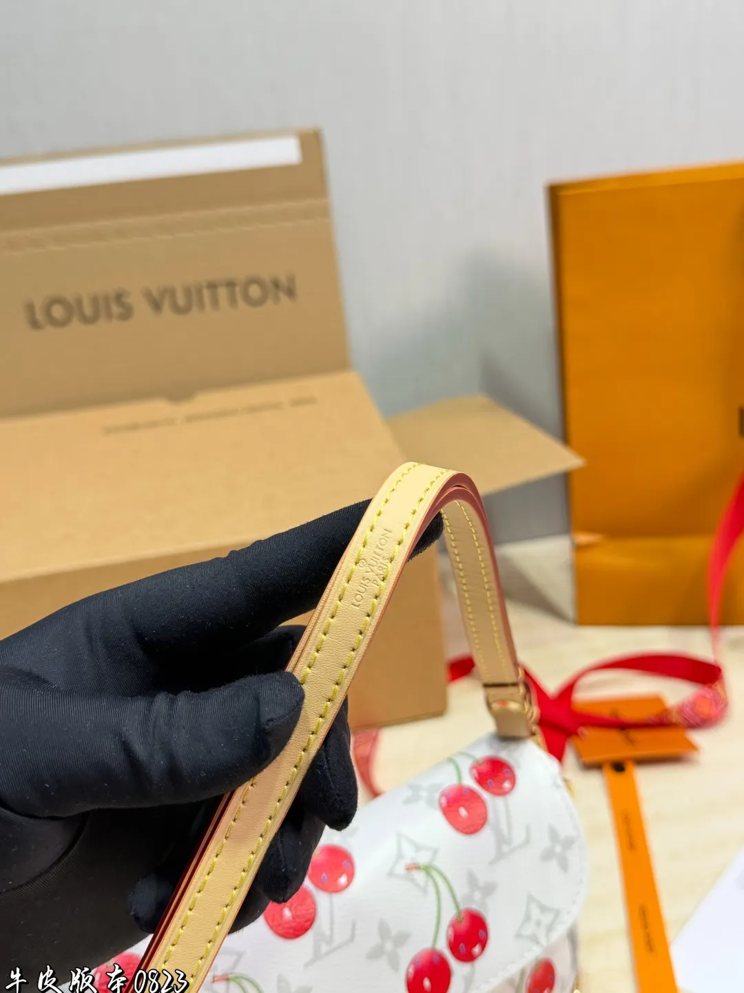 1:1Louis Vuitton Cherry Pochette Accessoires Monogram canvas bag with luxury packaging on table - xiashu