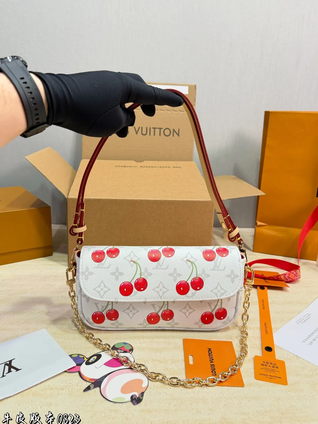 1:1Louis Vuitton Cherry Pochette Accessoires Monogram canvas bag with luxury packaging on table - xiashu