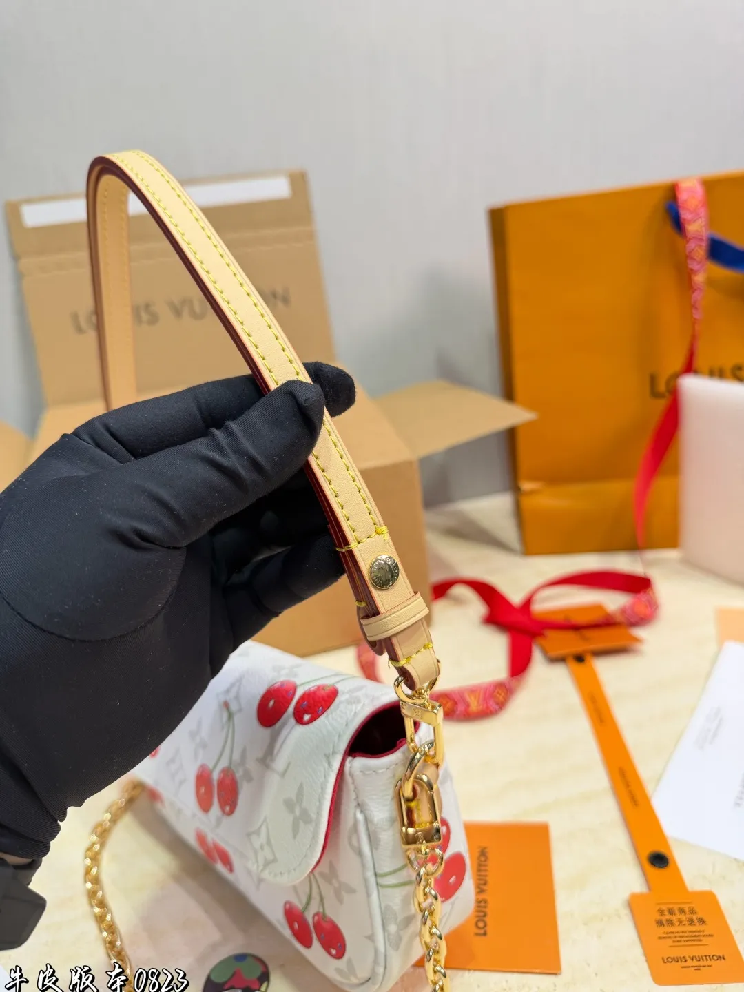 1:1Louis Vuitton Cherry Pochette Accessoires Monogram canvas bag with luxury packaging on table - xiashu