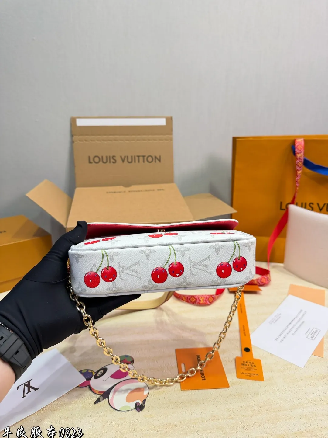 1:1Louis Vuitton Cherry Pochette Accessoires Monogram canvas bag with luxury packaging on table - xiashu