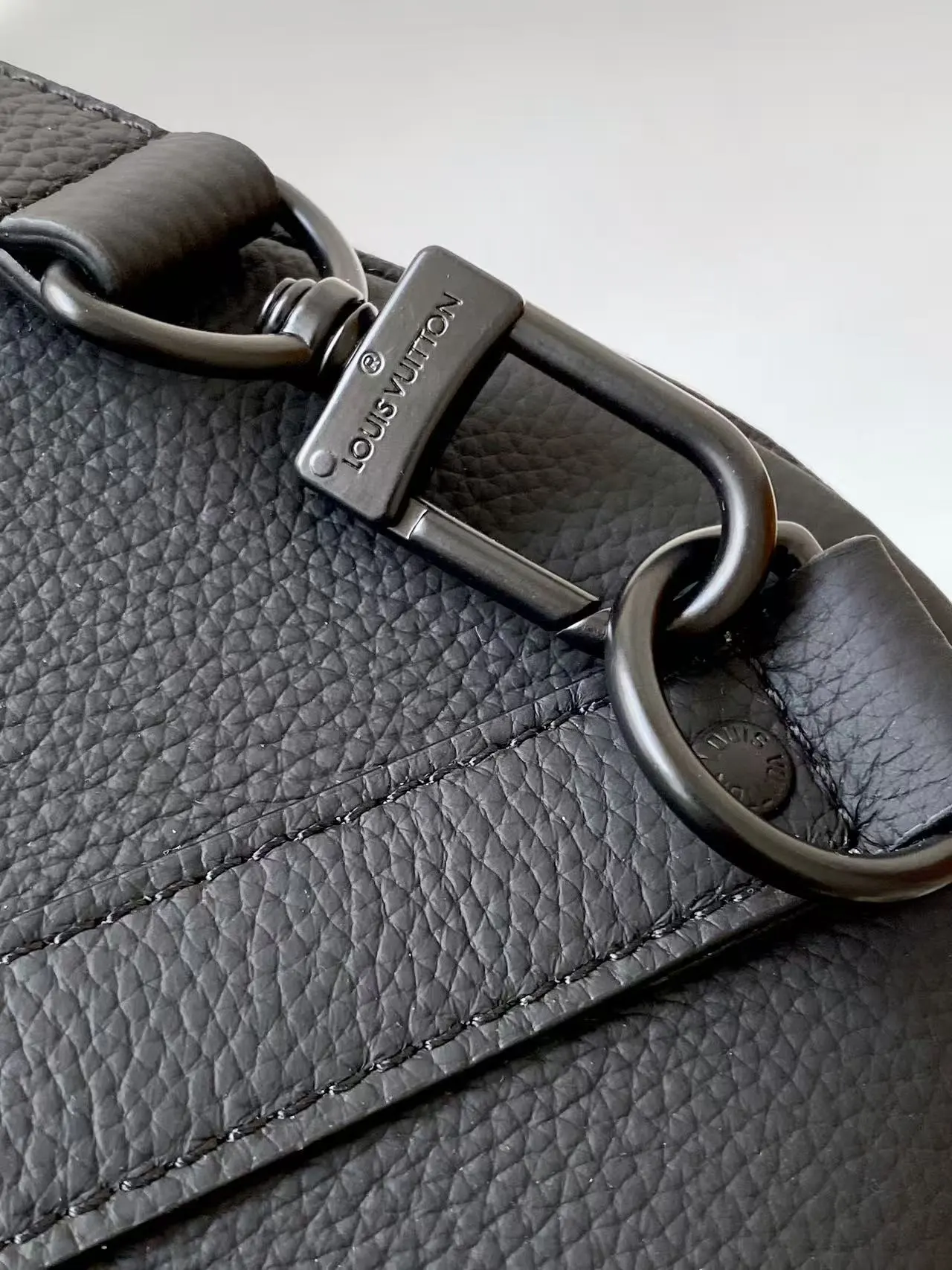 Louis Vuitton Keepall Bandouli&egrave;re 1:1 Aerogram black leather travel bag on a white chair - xiashuluxe