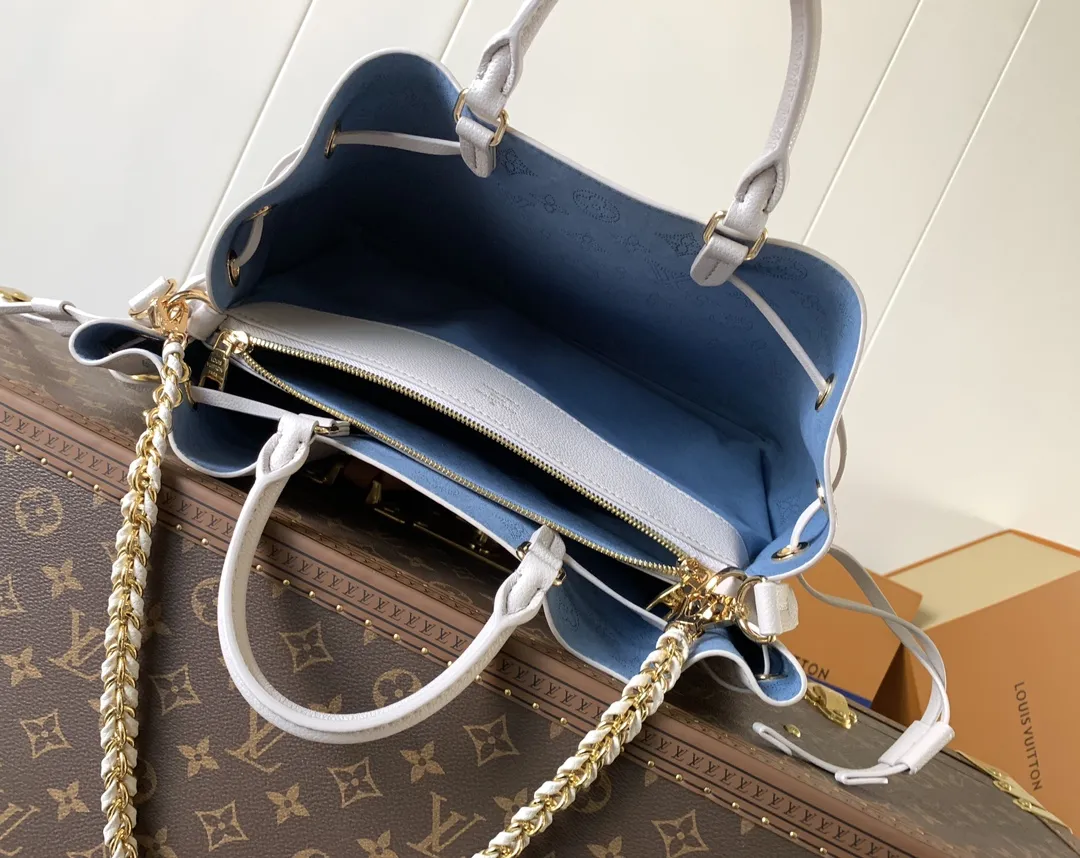 1:1Louis Vuitton Bella bucket bag in white Mahina perforated leather on a luxury trunk - xiashuluxe