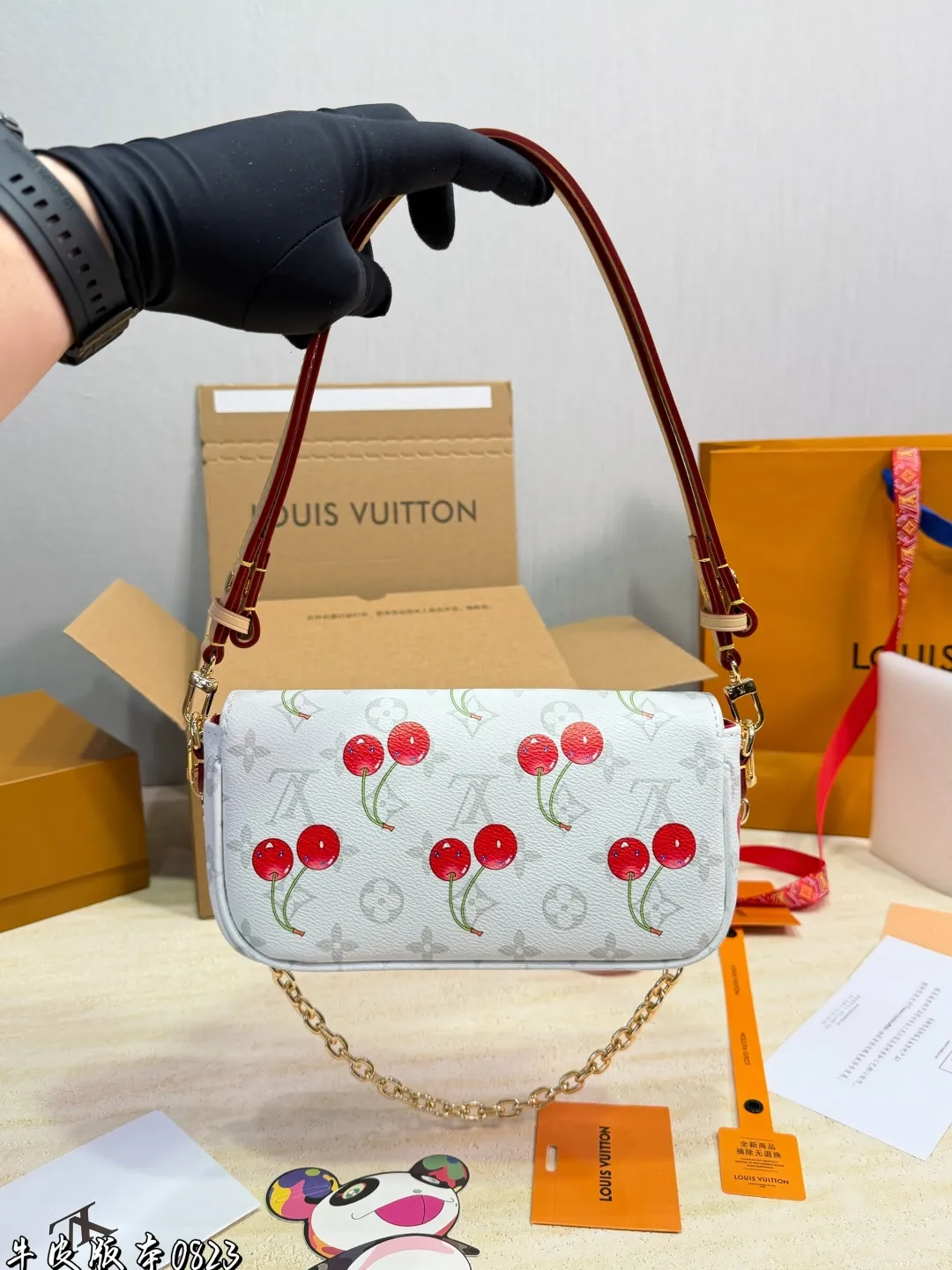 1:1Louis Vuitton Cherry Pochette Accessoires Monogram canvas bag with luxury packaging on table - xiashu