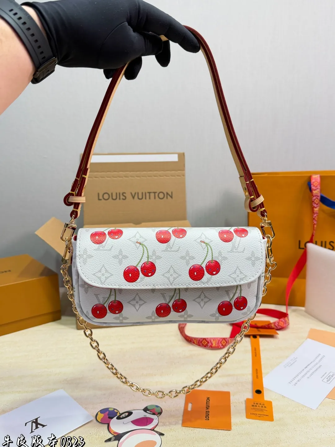 1:1Louis Vuitton Cherry Pochette Accessoires Monogram canvas bag with luxury packaging on table - xiashu