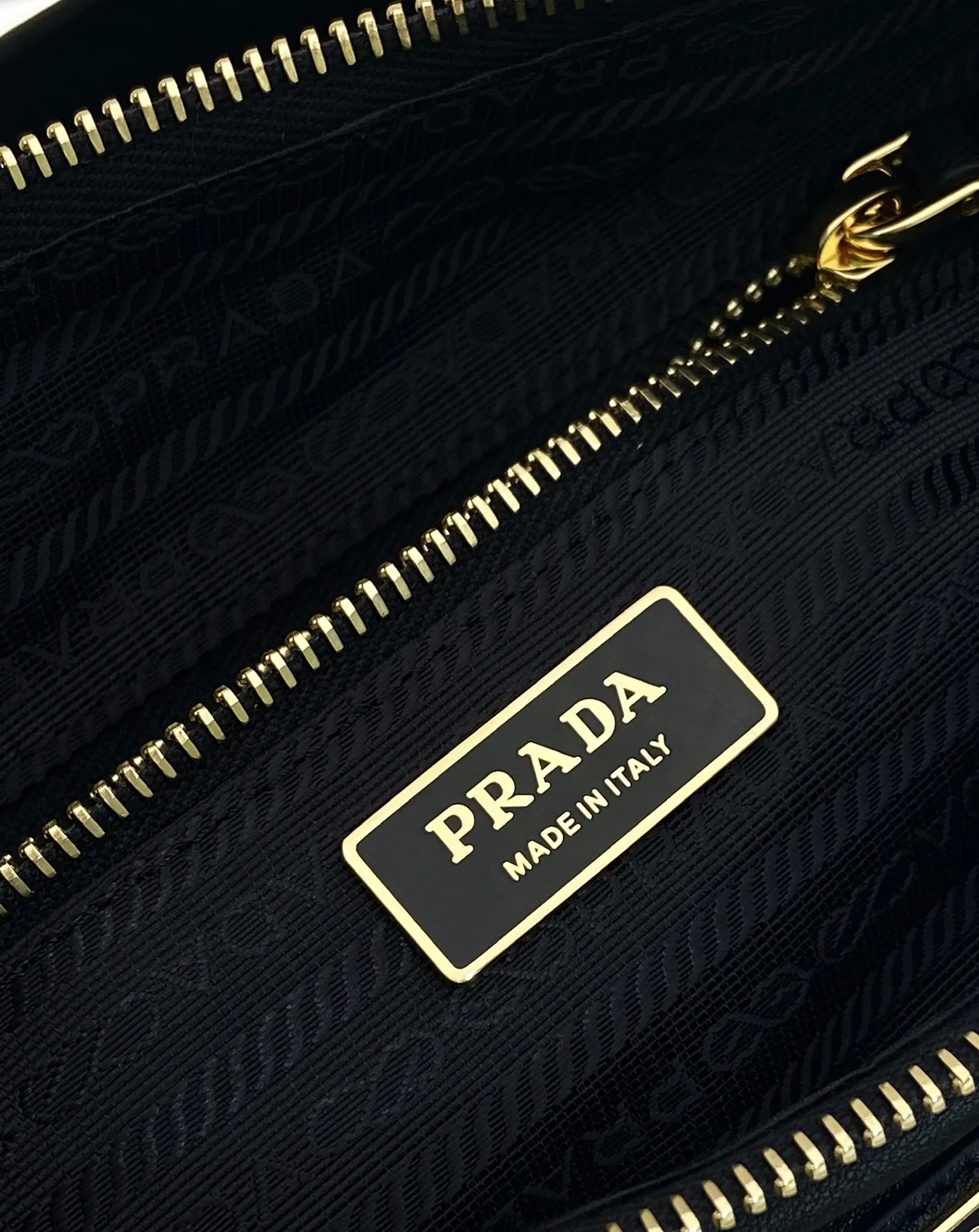 Prada 1:1 premium soft grained leather hobo bag in black with triangle logo and dual shoulder straps on display stand - xiashuluxe