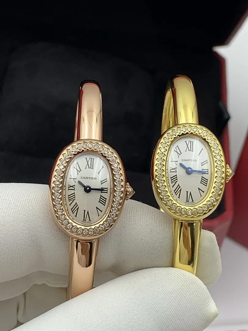 Cartier 1:1 premium Baignoire bangle watch in 18K rose gold and yellow gold with diamond-set oval bezel on display - xiashuluxe