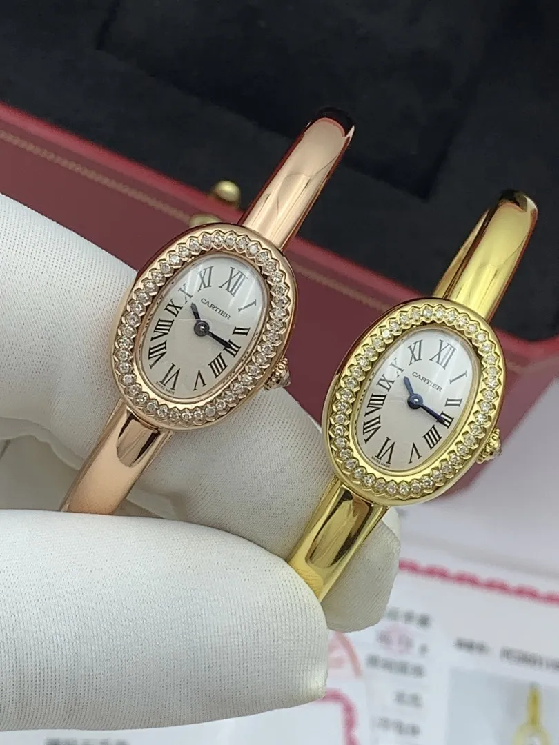 Cartier 1:1 premium Baignoire bangle watch in 18K rose gold and yellow gold with diamond-set oval bezel on display - xiashuluxe