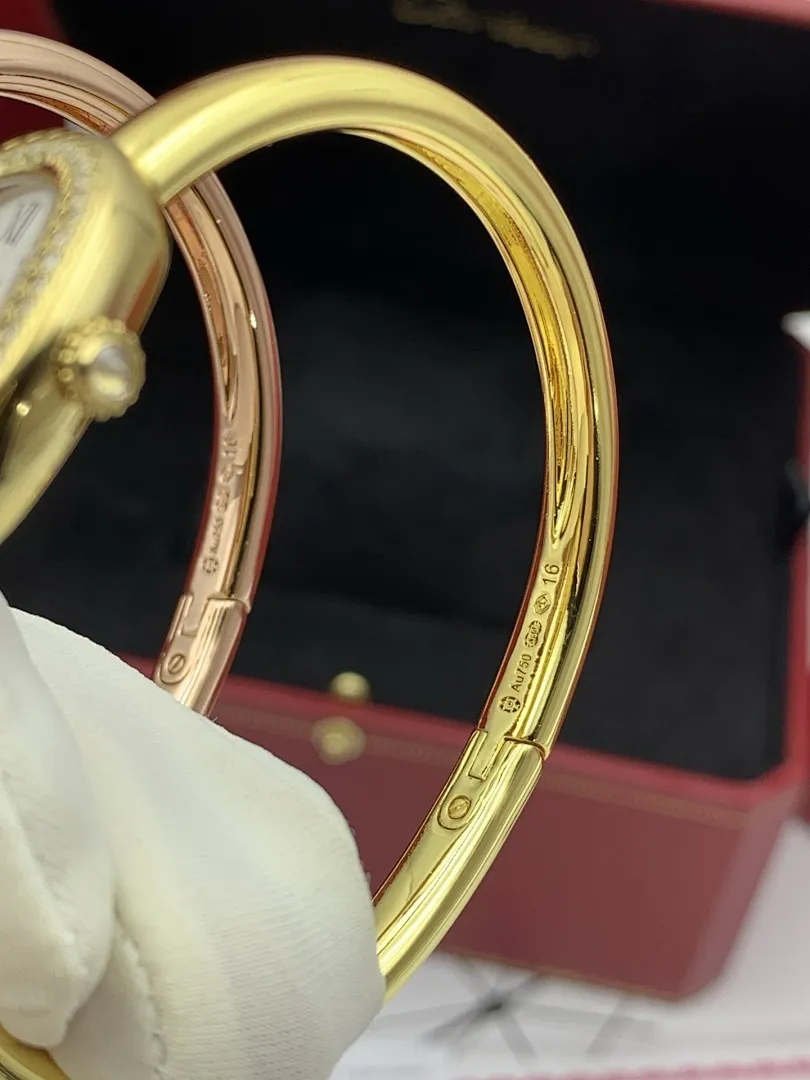 Cartier 1:1 premium Baignoire bangle watch in 18K rose gold and yellow gold with diamond-set oval bezel on display - xiashuluxe