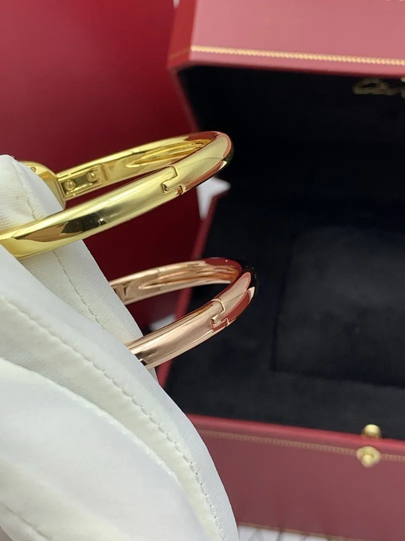 Cartier 1:1 premium Baignoire bangle watch in 18K rose gold and yellow gold with diamond-set oval bezel on display - xiashuluxe