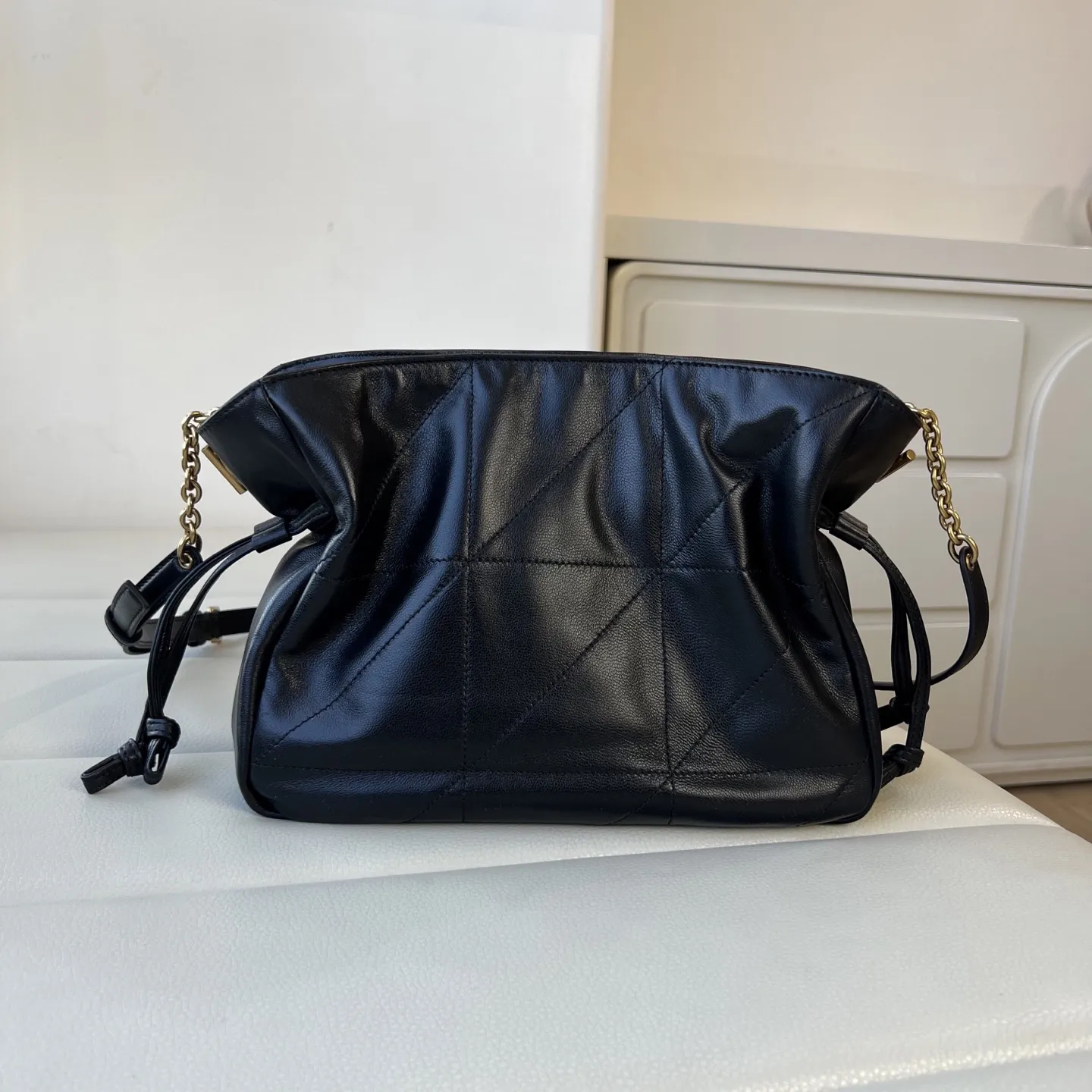 YSL 1:1 premium June Hobo bag in black quilted lambskin featuring gold-tone pivoting monogram closure and chain shoulder strap - xiashuluxe