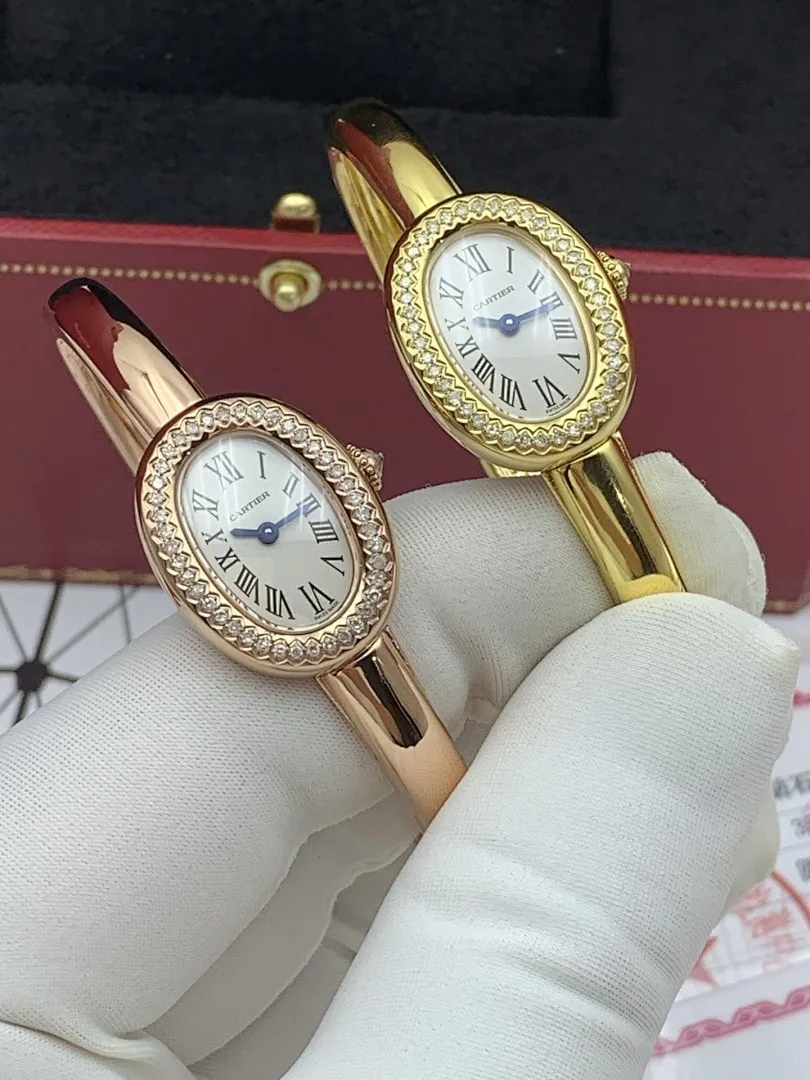 Cartier 1:1 premium Baignoire bangle watch in 18K rose gold and yellow gold with diamond-set oval bezel on display - xiashuluxe