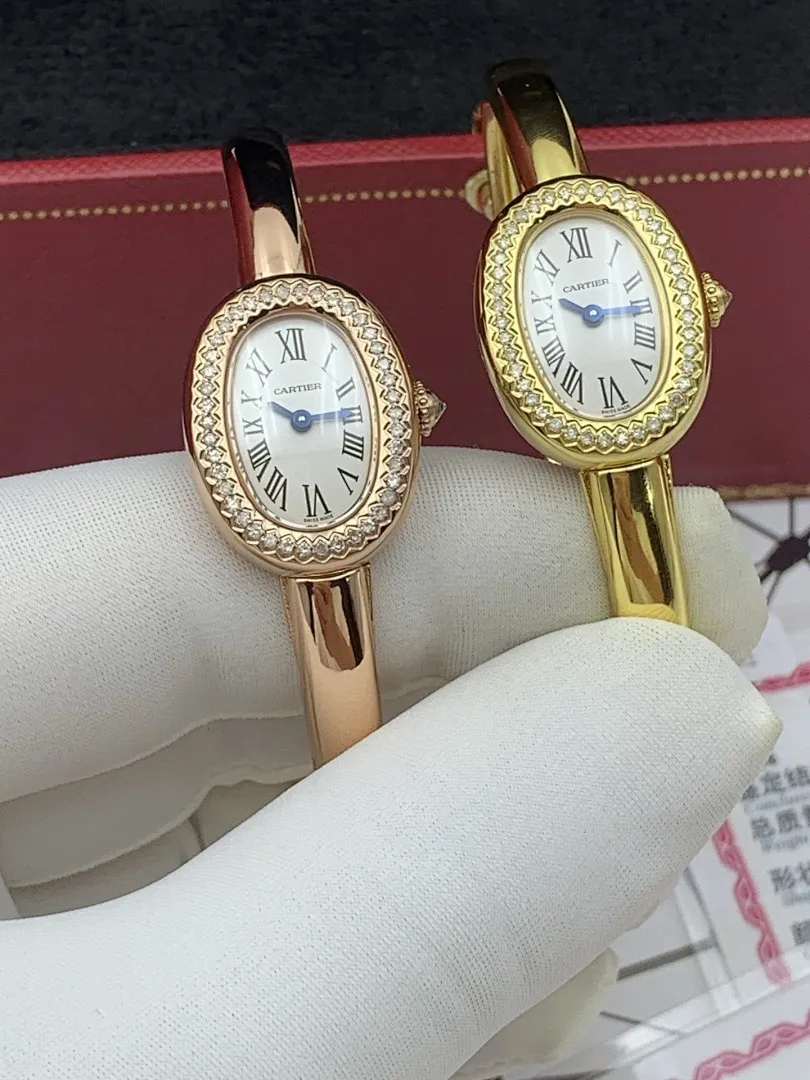 Cartier 1:1 premium Baignoire bangle watch in 18K rose gold and yellow gold with diamond-set oval bezel on display - xiashuluxe