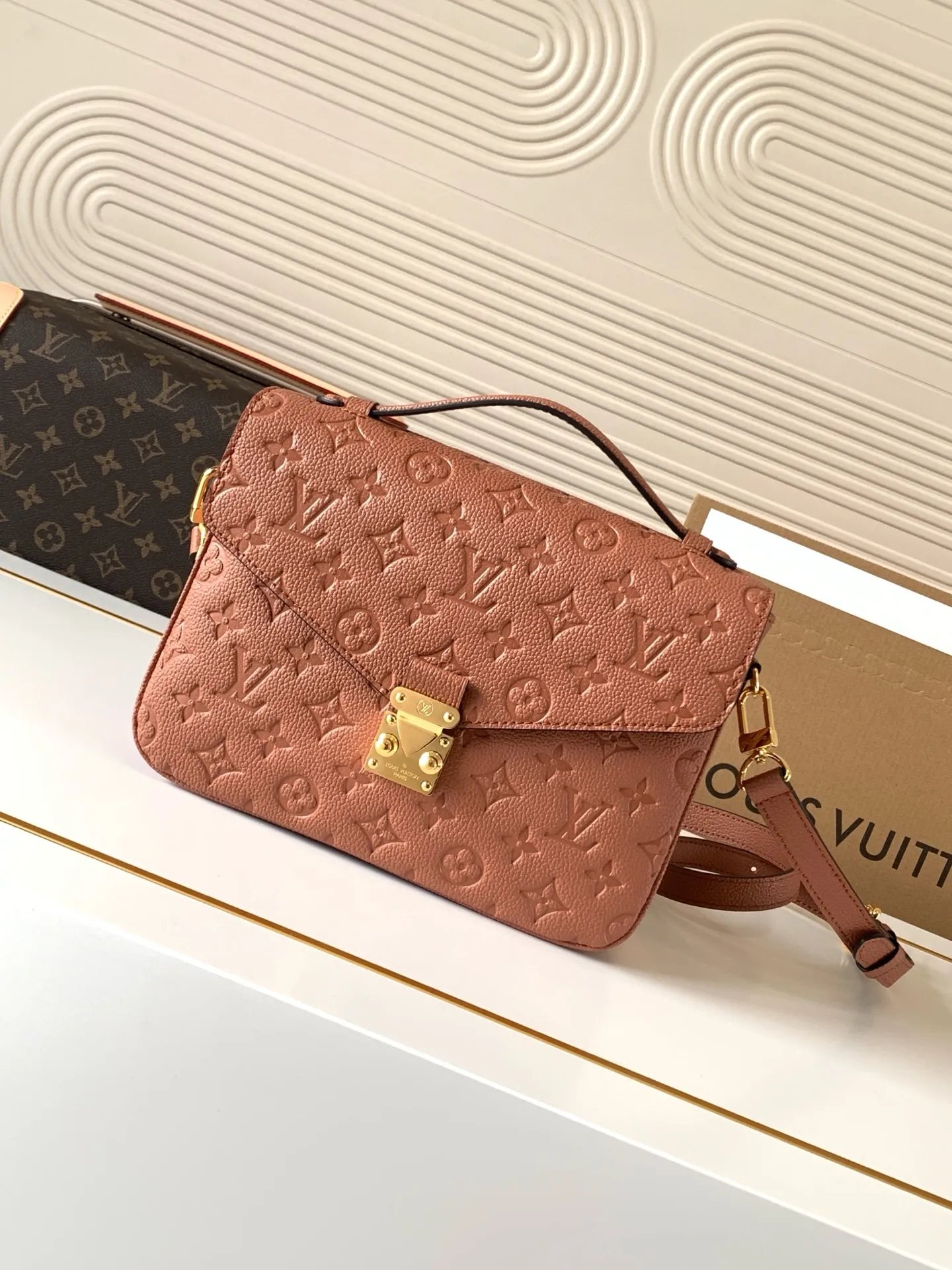 Front view of LV Pochette Métis bag in brown Monogram Empreinte leather with gold S-lock hardware