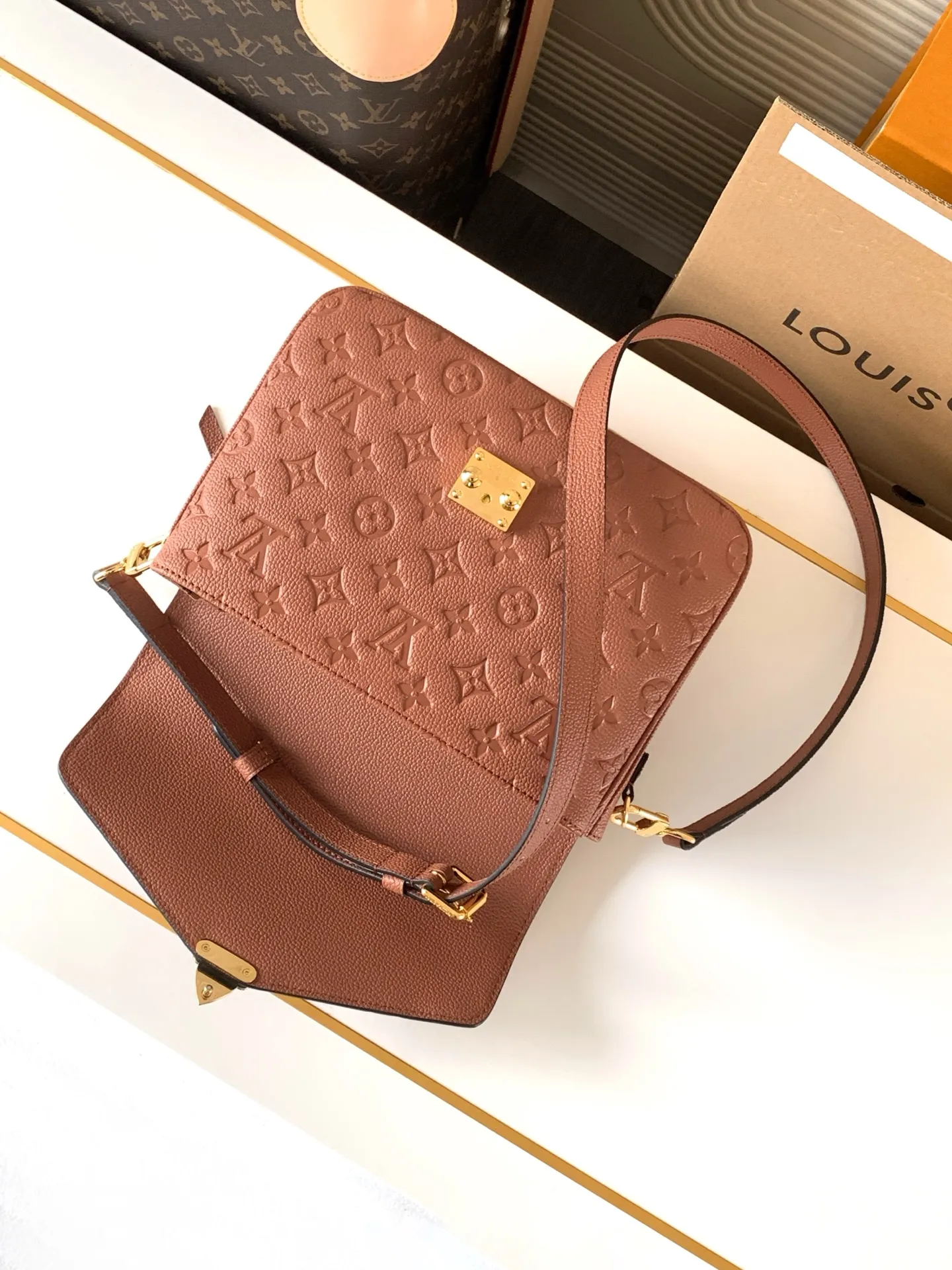 Rear view of the bag showing the external zipped pocket and smooth leather trim detail