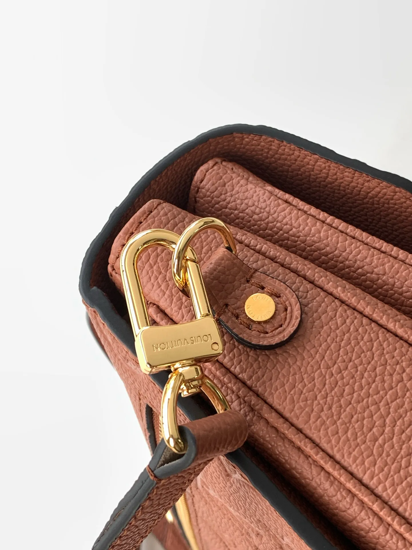 Detailed shot of the sturdy leather top handle and neat stitching on LV Pochette Metis