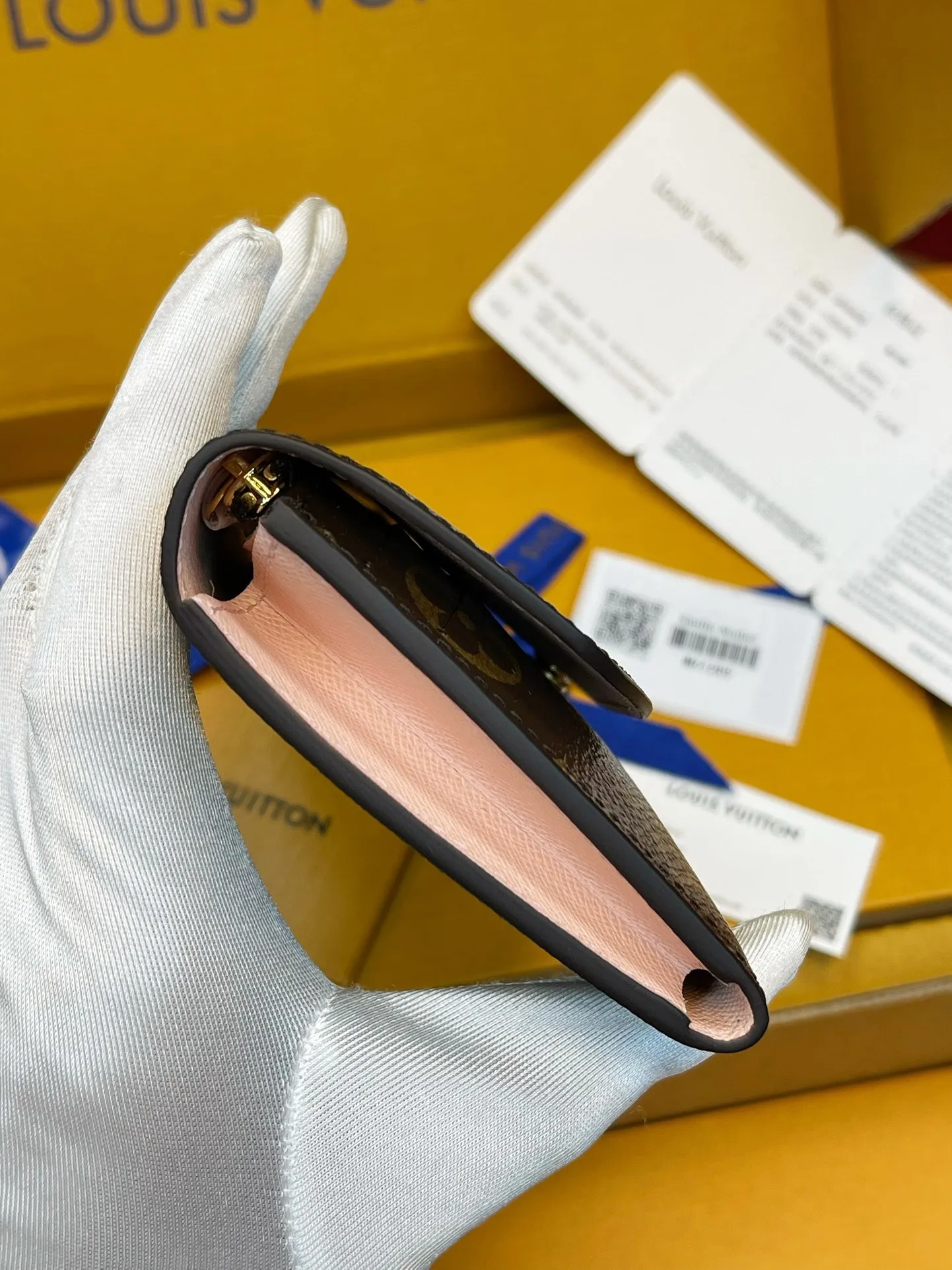 Detailed hardware shot of LV M61289 Adele wallet with high-grade steel