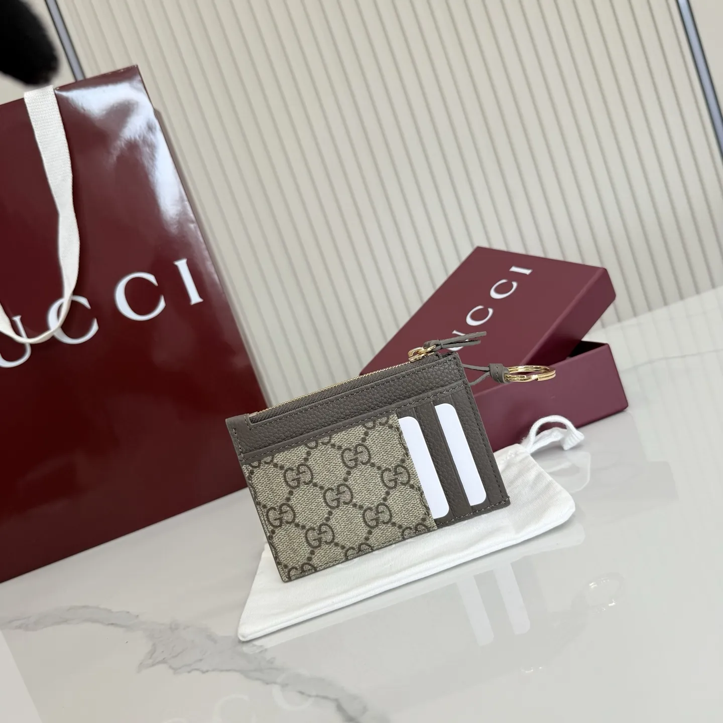 p160。【配全套包装】‼️Generation Gucci 系列深入探索品牌典藏元素,将不同年代的设计融合于一体,呈现出独特的美学叙事。GG Marmont 系列包含双色款式,如这款配有标志性双G造型配件的拉链钥匙包。 深灰褐色皮革 沙色和深棕色GG Supreme帆布滚边 金色调配件 深灰褐色塔夫绸衬里 双G 钥匙扣钩 内部:2个平底口袋,1个拉链口袋,4个卡片隔层 拉链开合 重量:约0.066千克 型号:837966。 尺寸:12厘米(宽)x 8.5厘米(高) 颜色:啡深灰褐色。 意大利创作