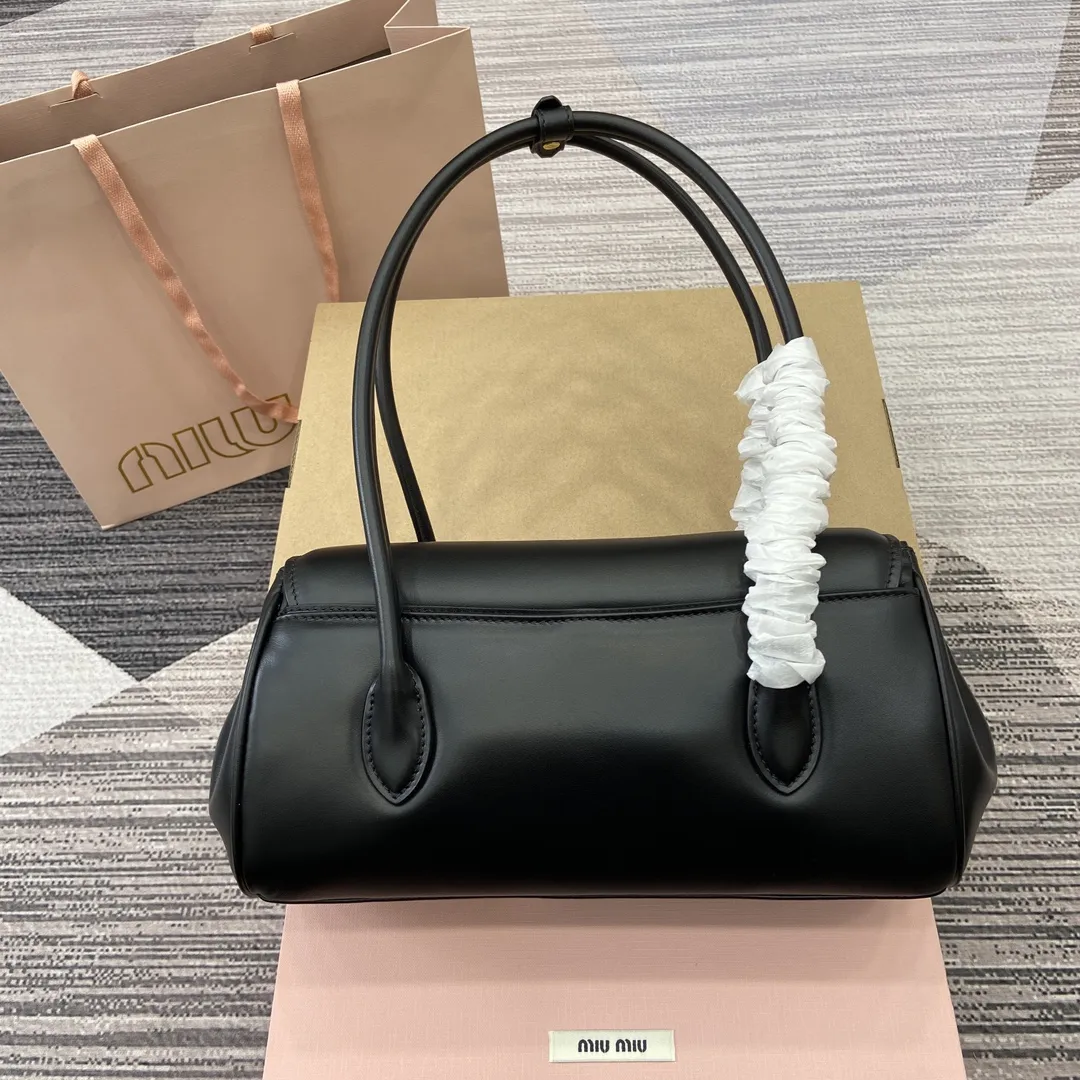 p900。【配全套专柜包装】‼️MIUMIU 24ss秋冬新款法棍包 法棍设计风格引领潮流新趋势，充满&rdquo;少女情怀&ldquo;围绕着书卷气展开，不羁且潇酒的大小姐风随意的人生态度，展现专属miumiu 女孩的独特，不大不小刚刚好的一只可甜辣可帅气 容量也满足日常出门所需好看又实用 很难不爱它诶！ 型号：5BD265。 28x11x15cm：28x11x15cm。 颜色：黑色全皮/原厂皮。